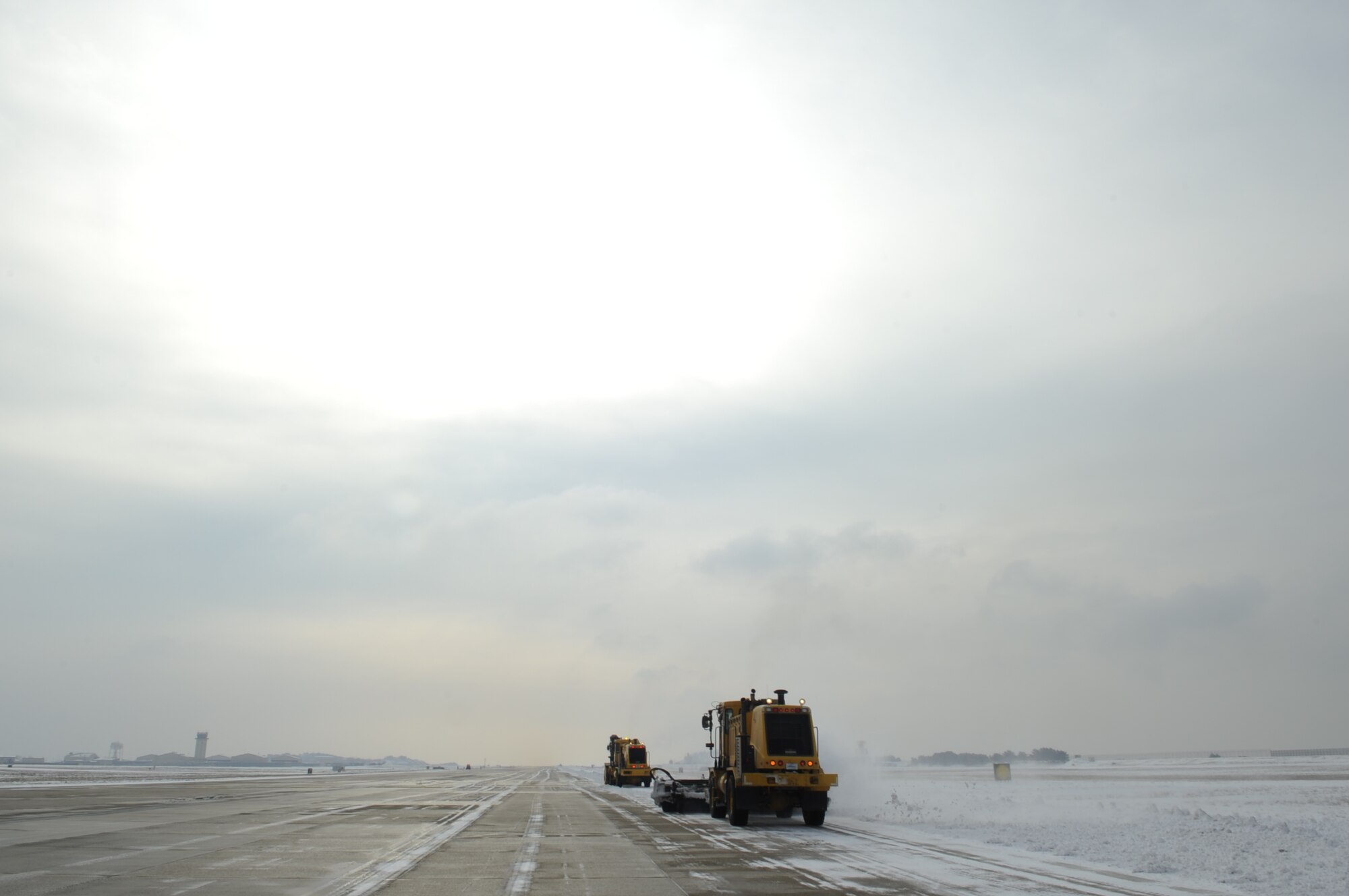 Airmen from the 8th Civil Engineer Squadron remove snow from the flightline Dec. 28, 2012, at Kunsan Air Base, Republic of Korea. Snow removal is a joint effort between multiple CE shops and requires them to work 12-hour shifts to keep the base’s flightline functional. (U.S. Air Force photo by Senior Airman Brigitte N. Brantley/Released)