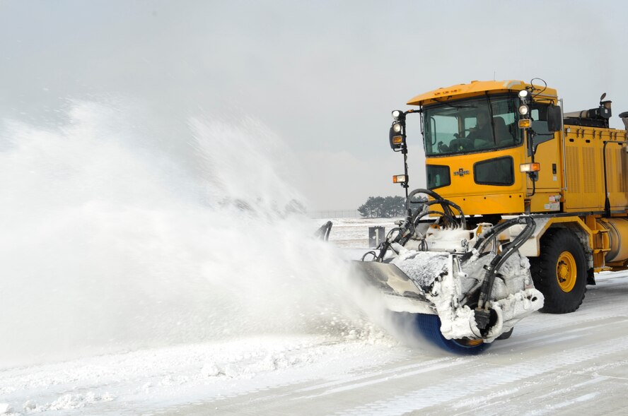 Senior Airman Daniel Franco, 8th Civil Engineer Squadron, clears the flightline after a heavy snowfall Dec. 28, 2012, at Kunsan Air Base, Republic of Korea. Although most of the snow removal team are “Dirt Boys,” the emergency management and explosive ordnance disposal flights also contribute Airmen to help with the cleanup effort. (U.S. Air Force photo by Senior Airman Brigitte N. Brantley/Released)