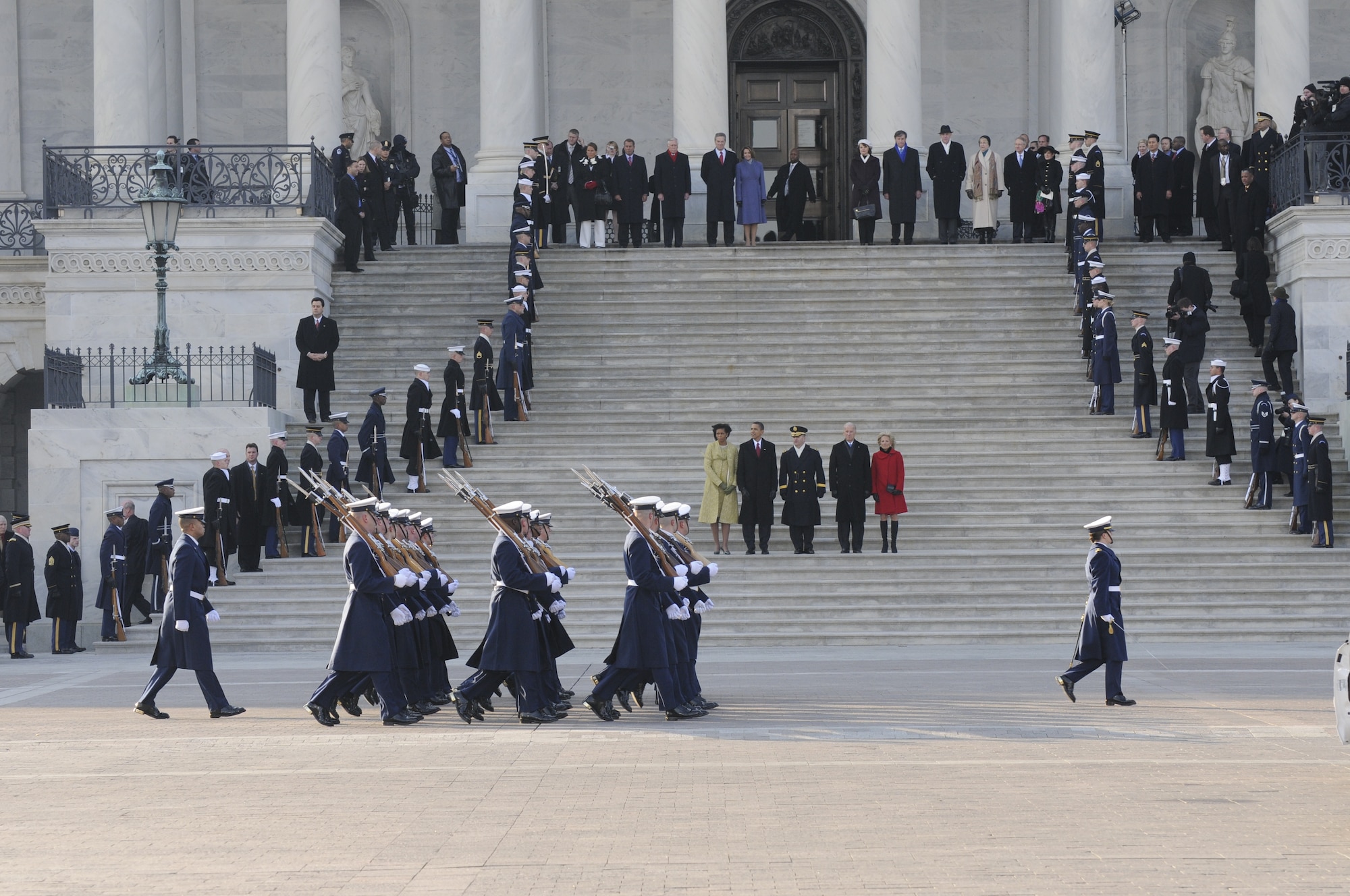 Vice President Joe Biden, Jill Biden, Michelle Obama and President Barack Obama stand on the U.S. Capitol east steps as former president George W. Bush and Laura Bush prepare to take off in Marine Corps helicopter (HMX-1) following the 56th Presidential Inauguration in Washington, D.C., Jan. 20, 2009. More than 5,000 men and women in uniform will be providing military ceremonial support to the 2013 presidential inauguration, a tradition dating back to George Washington's 1789 inauguration. (Photo by Public Affairs Specialist 1st Class Kyle Niemi, U.S. Coast Guard/Released)