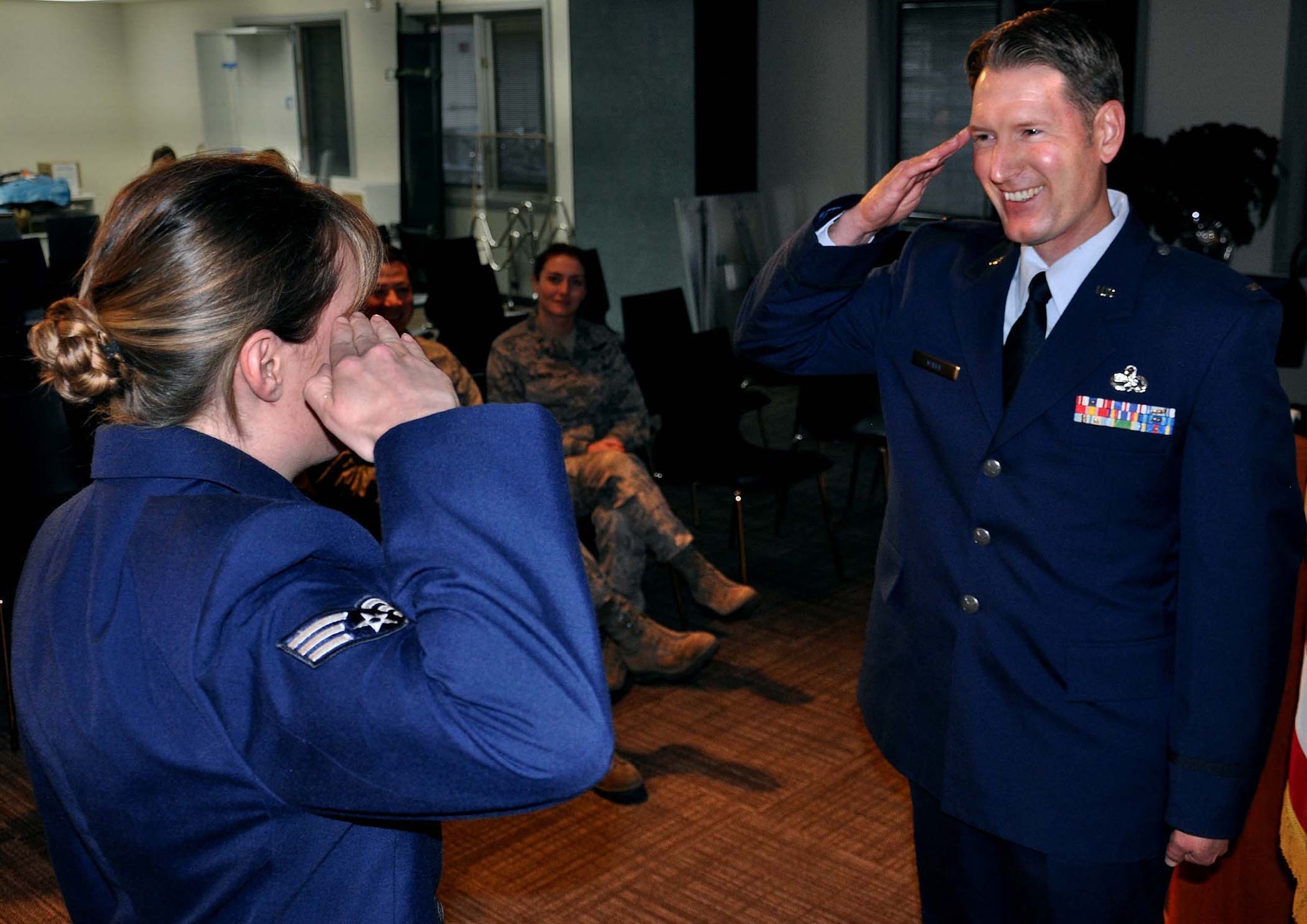 Senior Airman Julie Mann, a health services manager with the 446th Aeromedical Evacuation Squadron here, salutes 2nd Lt. Nathan Mann, Dec. 28.  Lieutenant Mann is a maintenance officer with the 129th Maintenance Group at Moffett Field, Calif.   Airman Mann is saluting her older brother for his first salute as an officer since graduating Officer Training School. (U.S. Air Force Photo/Airman 1st Class Madelyn McCullough)
