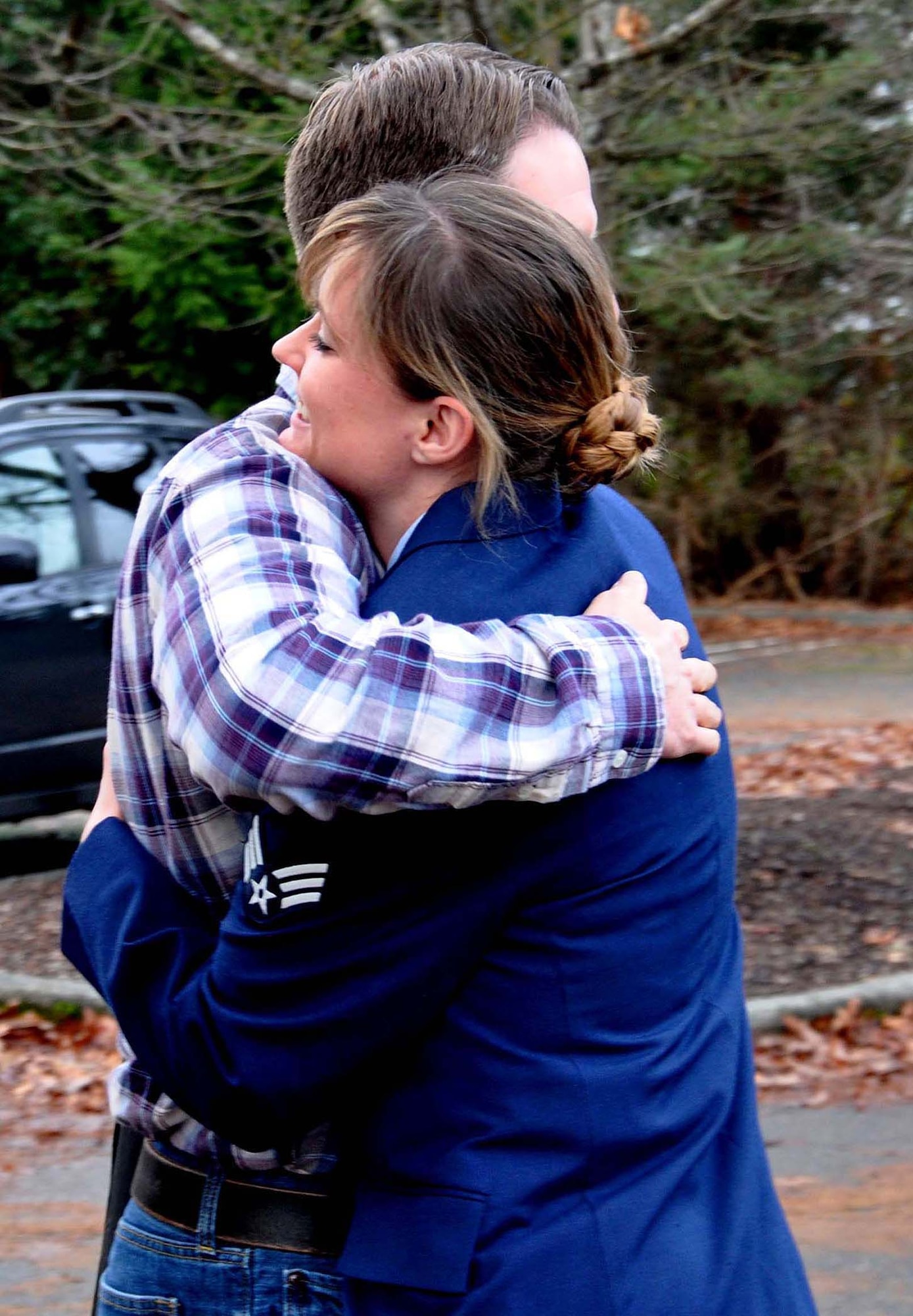 Senior Airman Julie Mann, a health services manager with the 446th Aeromedical Evacuation Squadron here, hugs her older brother 2nd Lt. Nathan Mann, Dec. 28. He is a maintenance officer with the 129th Maintenance Group at Moffett Field, Calif. Mann came to base in civilian attire to avoid being saluted by other Airmen so his younger sister would be the first to salute him as a new officer.  (U.S. Air Force Photo/Airman 1st Class Madelyn McCullough)