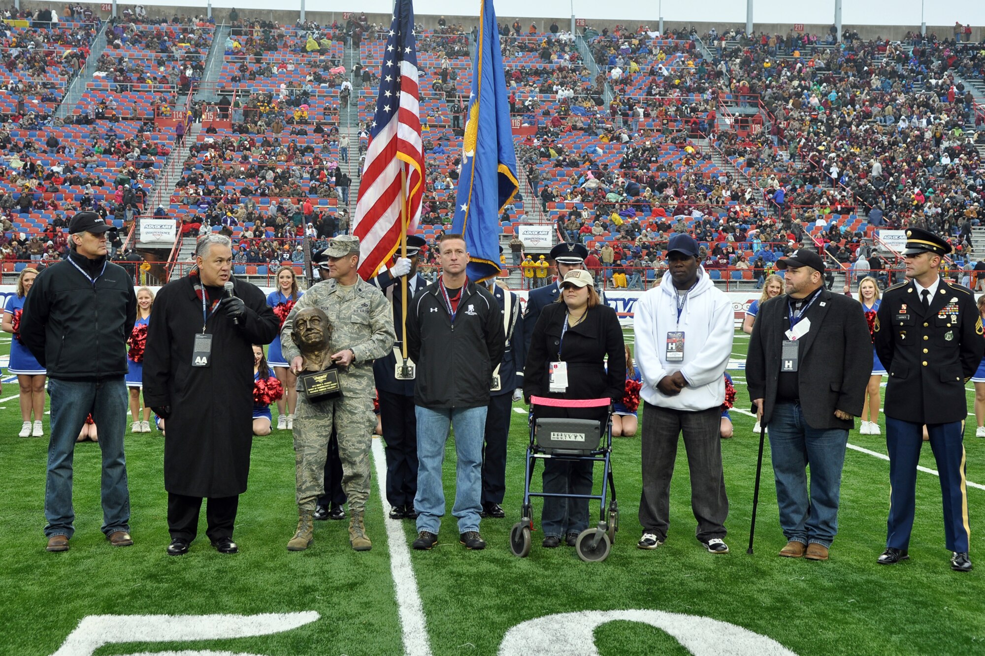 Advocare V-100 Independence Bowl 2012 Chairman Jack Andres Jack presents the 2012 Omar N. Bradlet “Spirit of Independence Award” to representatives of the Wounded Warrior Project during halftime ceremonies at the Independence Bowl in Shreveport, La., Dec. 28, 2012. The Ohio Bobcats faced off against the Louisiana Monroe University Warhawks in the contest and came out with the win 45-14. The Employer Support of the Guard and Reserve donated approximately 600 hundred tickets for local military members and their families to enjoy the game. (U.S. Air Force photo by Master Sgt. Jeff Walston)