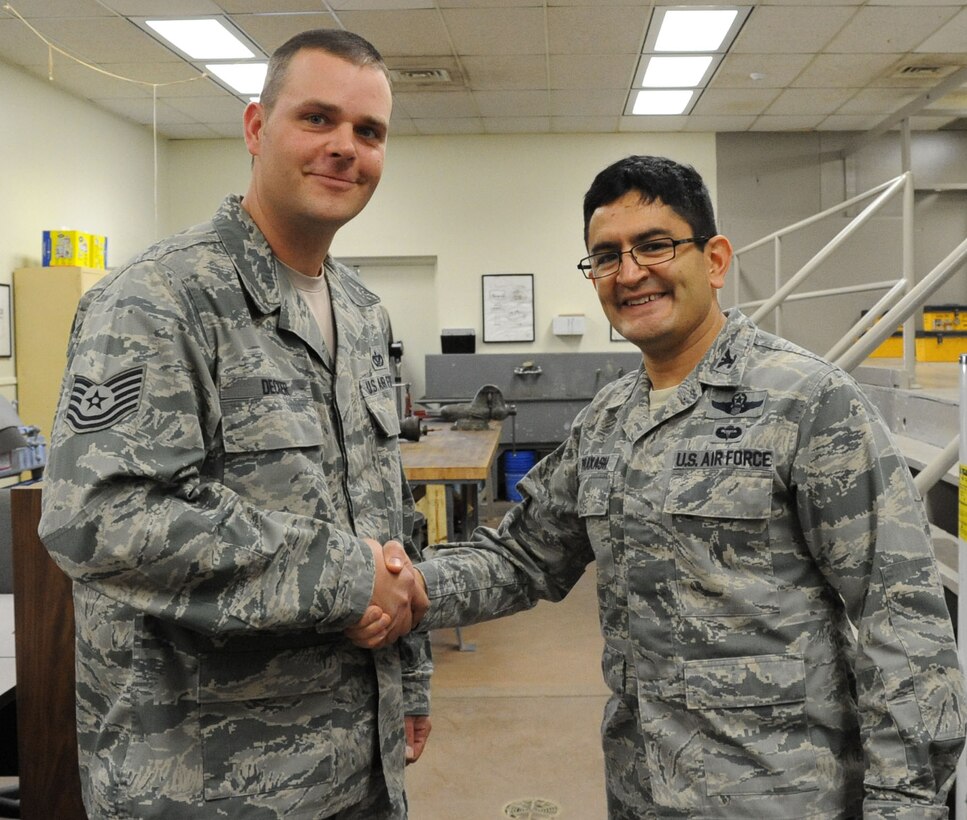 Col. Om Prakash (right), 82nd Training Wing vice commander, congratulates Tech. Sgt. Christopher Decker, 366th Training Squadron, on his selection as the 82nd TRW "Commander's Wingman of Choice" for Dec. 31 - Jan. 4.  Decker was recognized Jan. 2 and awarded a wing coin. (U.S. Air Force photo/Dan Hawkins)
