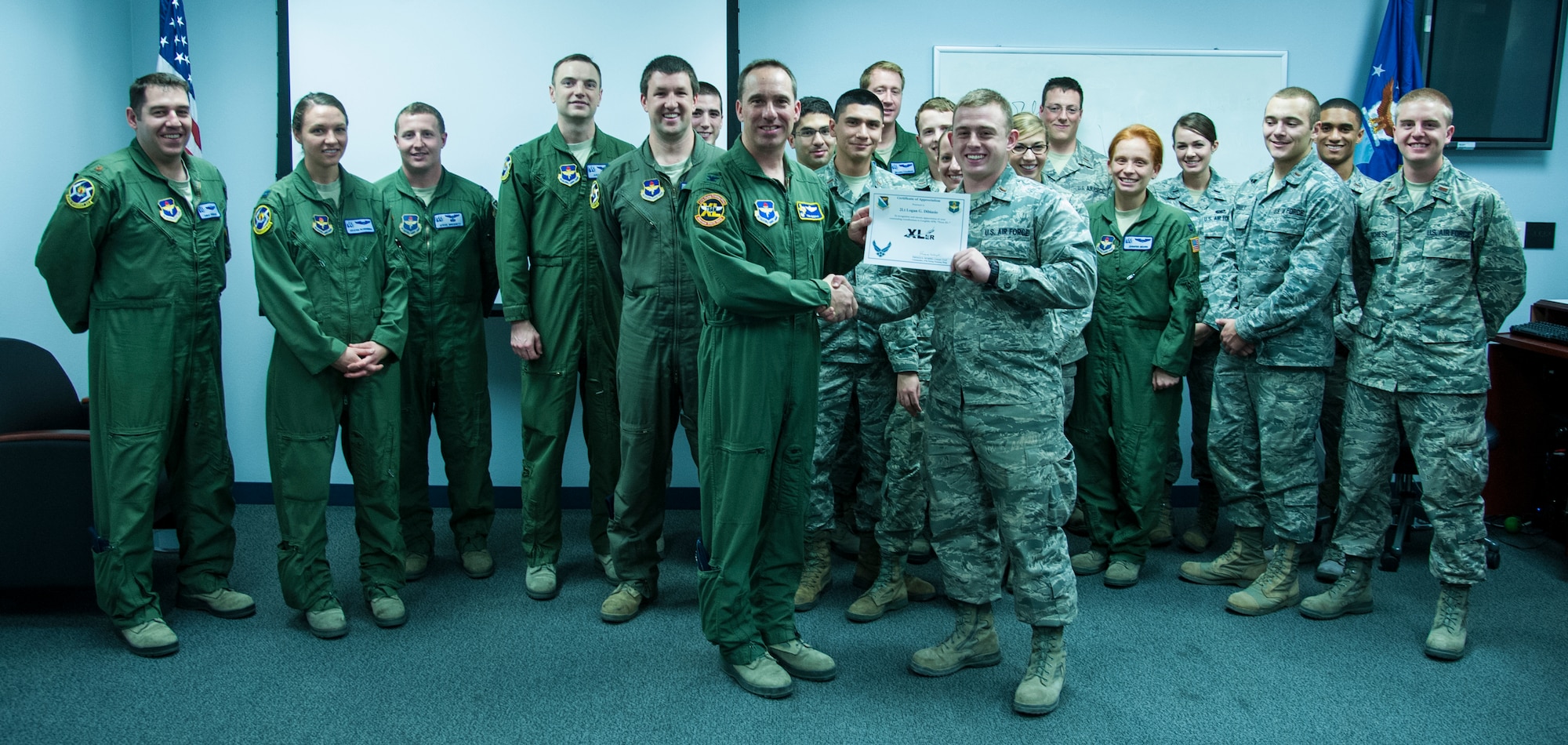 2nd Lt. Logan Dibiasio, 47th Student Squadron, poses with Col. Tom Murphy, 47th Flying Training Wing commander, after being presented the XLer of the Week Award at Laughlin Air Force Base, Texas, Dec. 19, 2012. The XLer is a weekly award chosen by wing leadership and given to those who consistently make outstanding contributions to Laughlin and their unit. (U.S. Air Force photo/Airmen 1st Class Nathan Maysonet)