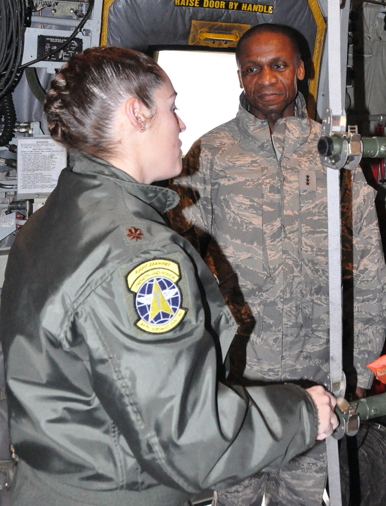 PETERSON AIR FORCE BASE, Colo. – Lt. Gen. Darren McDew, right, 18th Air Force commander, listens to flight nurse Maj. Carrie Williamson, 34th Aeromedical Evacuation Squadron, as she talks about the C-130’s aeromedical evacuation capabilities. McDew visited the 302nd Airlift Wing here Dec. 18-19  to meet with Airmen and see first-hand how the reserve wing is embracing Total Force Integration. The active duty 52nd Airlift Squadron first partnered with the 302nd AW in October 2009 as part of TFI. (U.S. Air Force photo/Tech. Sgt. Daniel Butterfield)