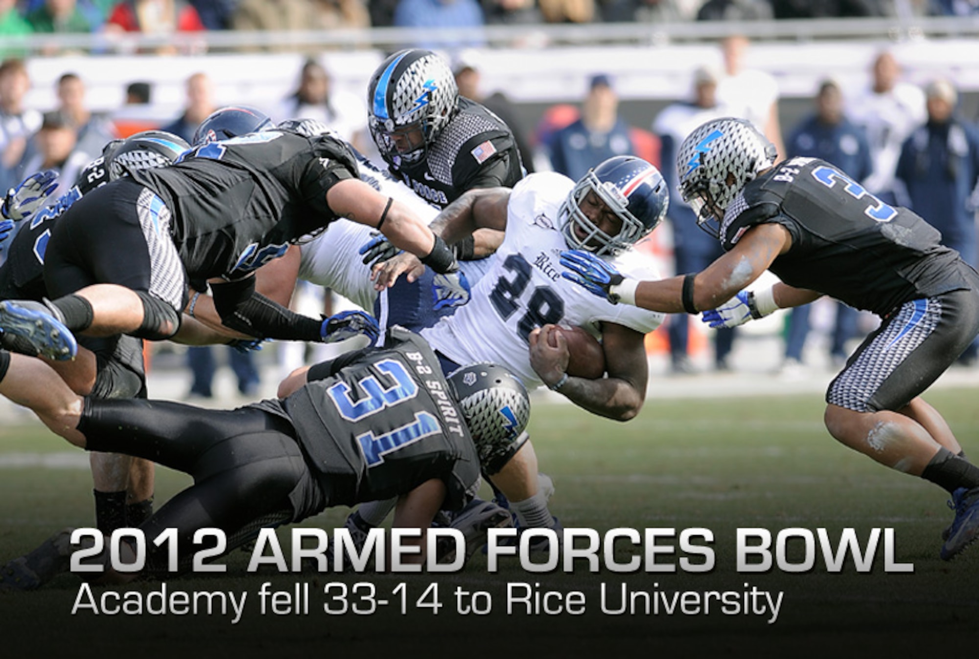 Rice running back Charles Ross is dragged down during the 2012 Armed Forces Bowl by a host of falcon defenders, including defensive backs Brian Lindsay, bottom, and Chris Miller, right. The bowl game was held December 28 in Ft. Worth, Texas. (U.S. Air Force photo/Sarah Chambers) 
