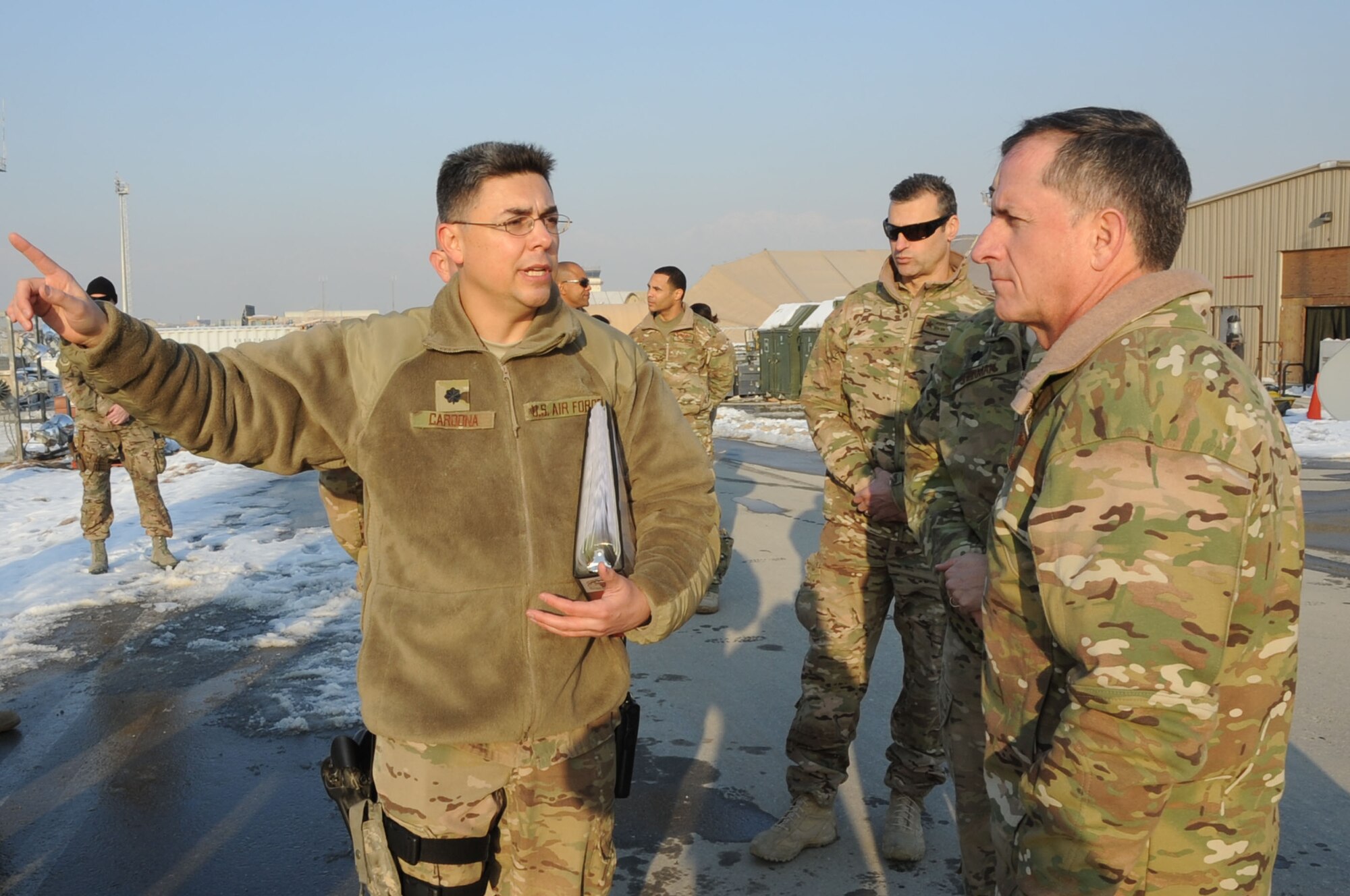 BAGRAM AIRFIELD, Afghanistan - Lt. Col. Rudy Cardona, 455th Expeditionary Aircraft Maintenance Squadron commander, briefs Lt. Gen. David Goldfein, U.S. Air Forces Central Command commander, about a new security program initiated by the 455th Expeditionary Maintenance Group on the flightline here, Dec. 31, 2012. The program integrates security forces and maintenance Airmen to better protect assets during potential ground attacks. (U.S. Air Force photo/Staff Sgt. David Dobrydney)