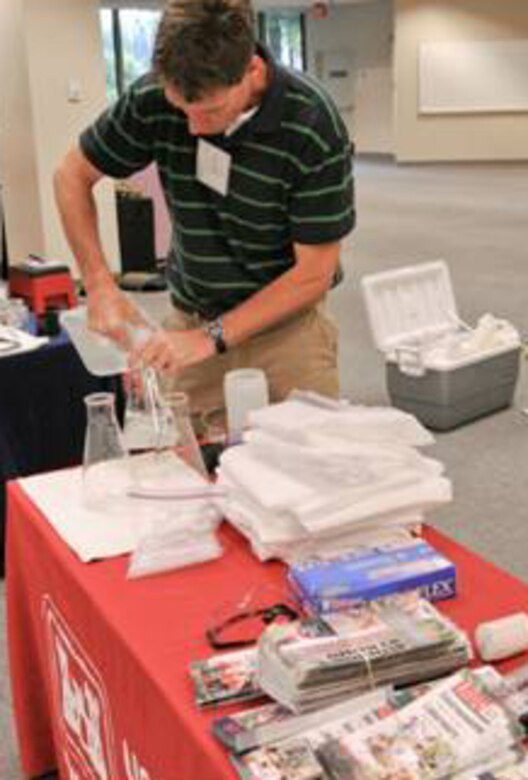 ERDC Environmental Laboratory’s Senior Scientist Dr. Jeffery Steevens prepares ERDC’s display and activities as part of the Corps booth for students attending the Science, Technology, Engineering and Mathematics Expo. 