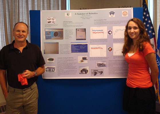 At the recent ERDC Cold Regions Research and Engineering Laboratory Student, Post-graduate and Post-doctorate Research Symposium, mentor Dr. Jim Lever, a mechanical engineer, and student intern Monica Preston poses with Preston’s poster “A Summer of Robotics.” 