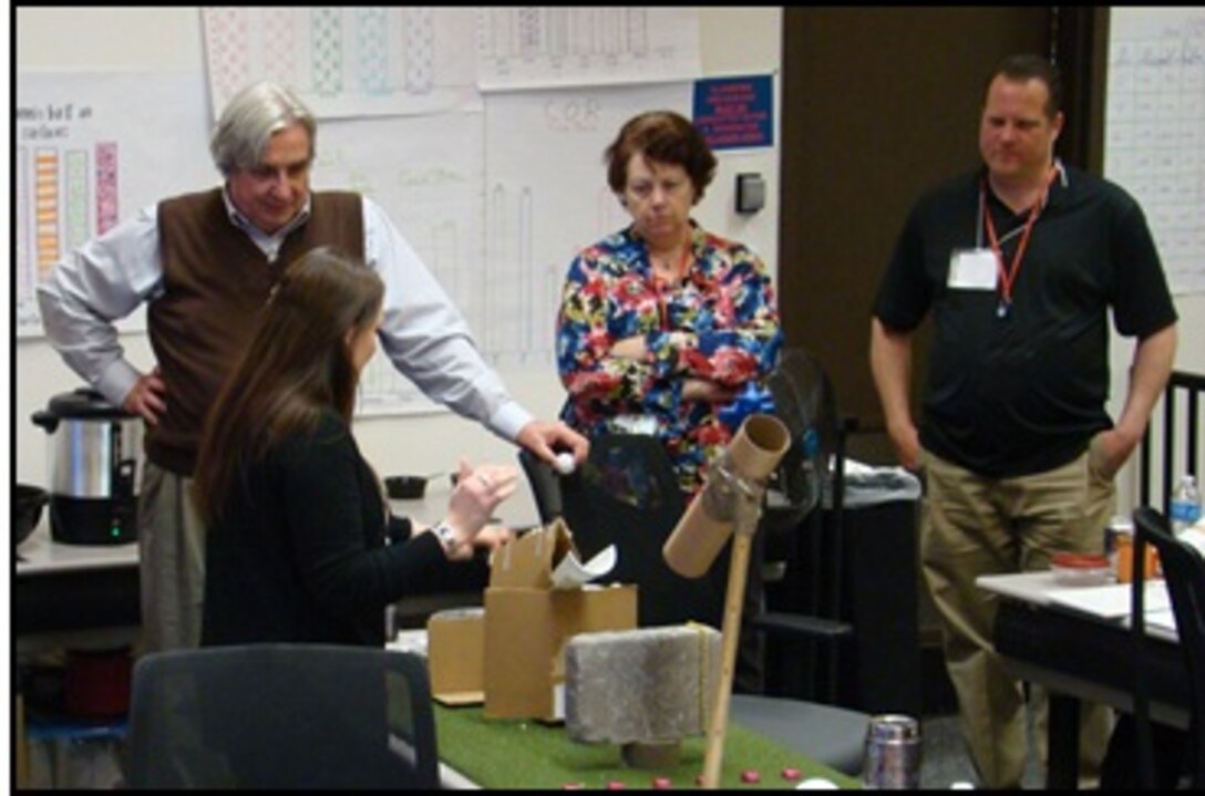 Master Teacher Stu Schultlz (left), National Center for the Advancement of Science, Technology, Engineering and Mathematics Education listens as a Fairfax County Public School teacher presents one of the group’s activities, as Nancy Towne (center), Army Geospatial Center and ERDC-GRL Physical Scientist Luke Catania (right) look on. 