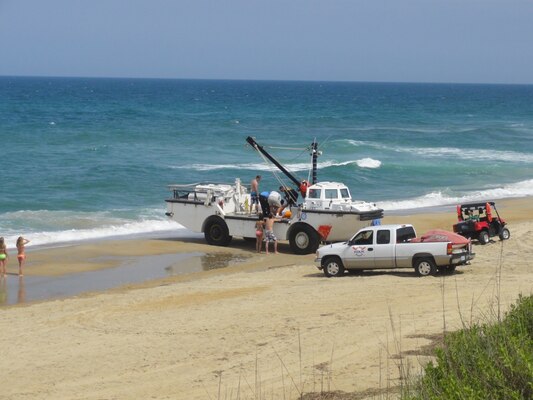 The Surf Rescue squad board the Engineer Research and Development Center (ERDC) Coastal and Hydraulics Laboratory (CHL) Lighter, Amphibious, Resupply, Cargo (LARC) after civil engineering technician Mark Preisser saves three swimmers from rip current in the Atlantic Ocean near Duck, N.C. Photo provided by CHL.