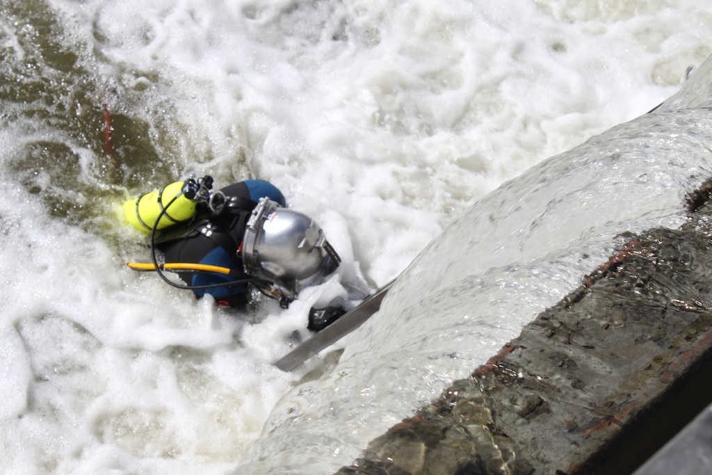 John Snell, diver and lock and dam operator at Starved Rock, begins his submersion to pull bearings on the wicket dam in preparation for dewatering operations.