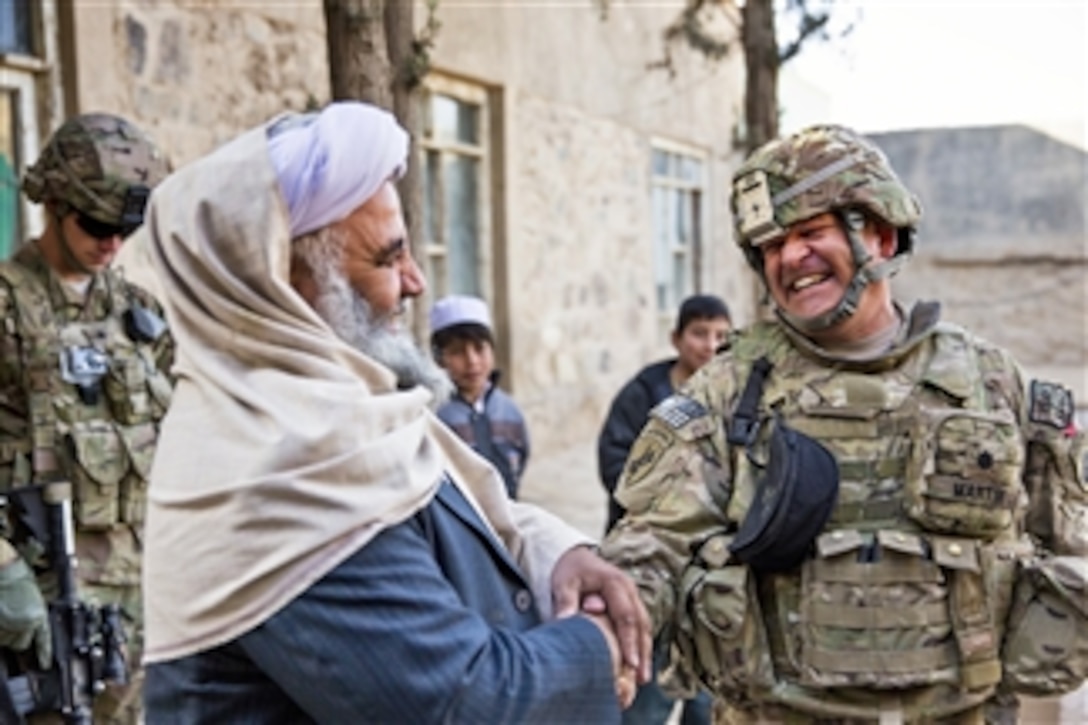 U.S. Army Lt. Col. Mark Martin, right, shakes hands and laughs with Mawlawi Guhlam M. Ruhaani, director of Hajj and Endowment, at the conclusion of a key leader engagement in Farah City, Afghanistan, on Dec. 29, 2012.  Martin is the team lead for Provincial Reconstruction Team Farah with the mission to train, advise and assist Afghan government leaders at the municipal, district and provincial levels in Farah province, Afghanistan.   The civil military team is comprised of members of the U.S. Navy, U.S. Army, the U.S. Department of State and the Agency for International Development.  