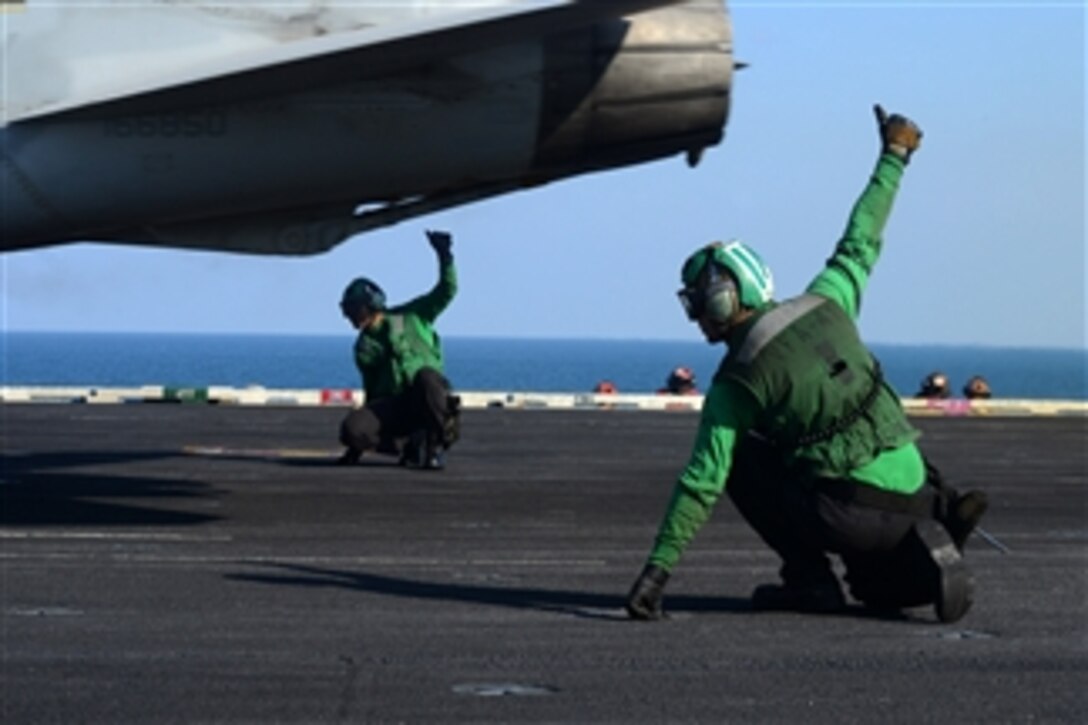 Flight deck crewmen give the thumbs up to launch an F/A-18F Super Hornet from the aircraft carrier USS John C. Stennis (CVN 74) as the ship operates in the Arabian Sea on Dec. 29, 2012.  The John C. Stennis Carrier Strike Group is deployed to the 5th Fleet area of responsibility to conduct maritime security operations and theater security cooperation efforts.  The Super Hornet is assigned to Strike Fighter Squadron 41.  