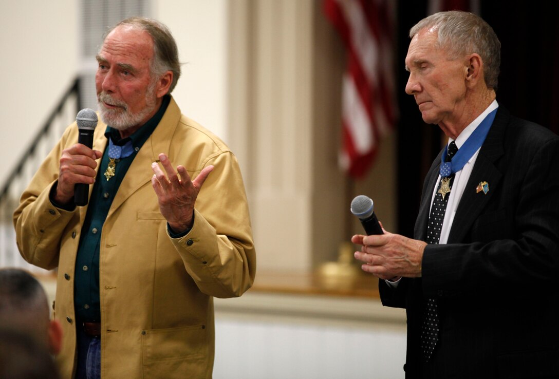 Retired Army Maj. Drew Dix (left) and retired Maj. Gen. James Livingston, two Medal of Honor recipients, speak with military spouses at the Russell Marine and Family Center aboard Marine Corps Base Camp Lejeune Dec. 11. Dix and Livingston visited the installation to speak with various battalions, and they made sure to take time out of their busy schedule to speak with military spouses about the important role they play in the household.