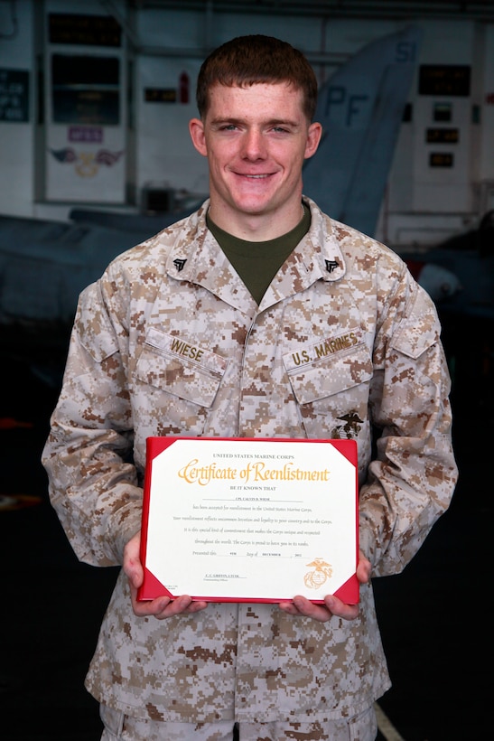 (Dec. 7, 2012) Corporal Calvin Wiese, company radio operator, Kilo Company, Battalion Landing Team 3/5, 15th Marine Expedititionary, re-enlisted Dec. 7, in the hangar bay of the USS Peleliu. The 15th MEU is deployed as part of the Peleliu Amphibious Ready Group as a U.S. Central Command theater reserve force, providing support for maritime security operations and theater security cooperation efforts in the U.S. 5th Fleet area of responsibility. (U.S. Marine Corps photo by Cpl. John Robbart III)