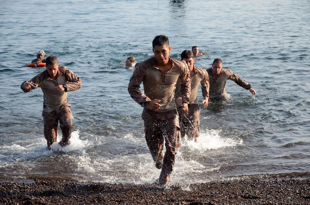 Marines assigned to the 15th Marine Expeditionary Unit (MEU) participate in a team-building water obstacle course at Arta Beach, Djibouti, Dec. 11. The 15th MEU is deployed as part of the Peleliu Amphibious Ready Group as a U.S. Central Command theater reserve force, providing support for maritime security operations and theater security cooperation efforts in the U.S. 5th Fleet area of responsibility. (U.S. Marine Corps photo by Cpl. Richard Sanglap-Heramis/Released)