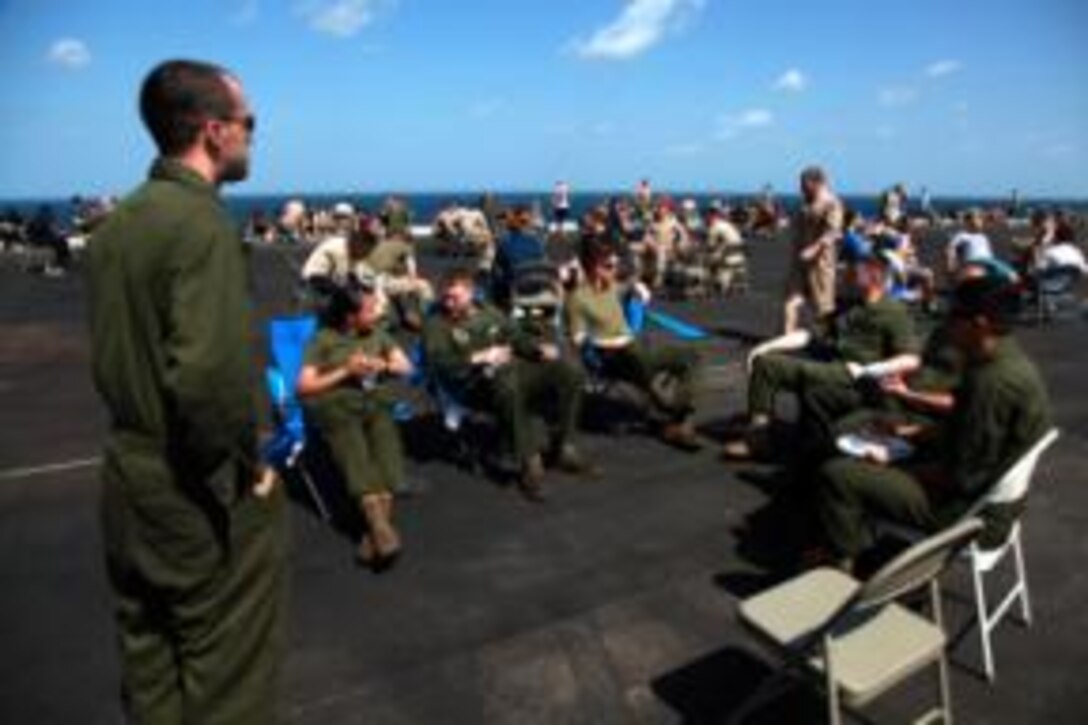 Marines and sailors with the 15th Marine Expeditionary Unit and Peleliu Amphibious Ready Group dance during a steel beach picnic held on the flight deck of the USS Peleliu, Jan. 1. The picnic was an opportunity for the blue-green team to relax at sea with food, drinks, music, football, boxing, tanning and socializing for the servicemembers who have been working hard since they left San Diego, Sept. 17. The 15th MEU is deployed as part of the Peleliu Amphibious Ready Group as a U.S. Central Command theater reserve force, providing support for maritime security operations and theater security cooperation efforts in the U.S. 5th Fleet area of responsibility. 