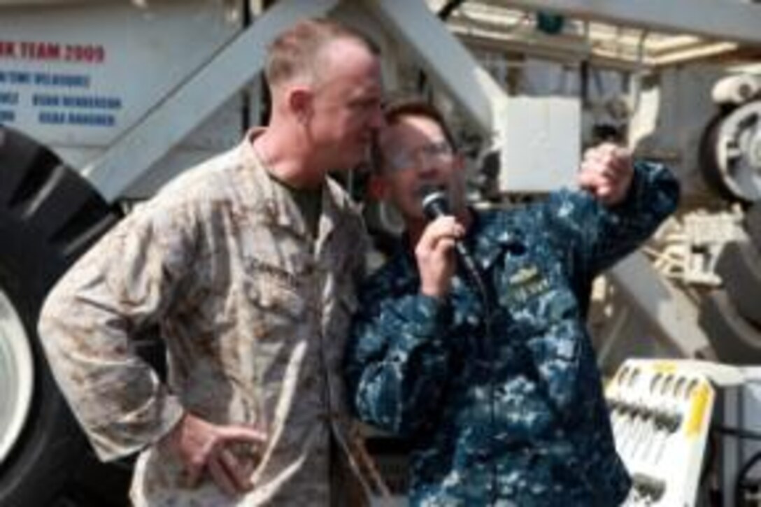 Marines and sailors with the 15th Marine Expeditionary Unit and Peleliu Amphibious Ready Group dance during a steel beach picnic held on the flight deck of the USS Peleliu, Jan. 1. The picnic was an opportunity for the blue-green team to relax at sea with food, drinks, music, football, boxing, tanning and socializing for the servicemembers who have been working hard since they left San Diego, Sept. 17. The 15th MEU is deployed as part of the Peleliu Amphibious Ready Group as a U.S. Central Command theater reserve force, providing support for maritime security operations and theater security cooperation efforts in the U.S. 5th Fleet area of responsibility. 