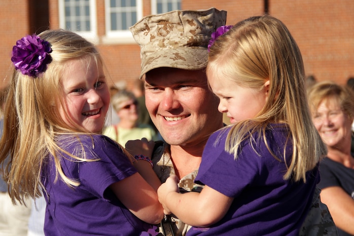 Capt. Chuck Larson, 31, from Des Moines, Iowa, holds his daughters Camille, 5, and Estelle, 3, after returning from Afghanistan on Sept. 9. Larson was one of 36 Marines with Marine Wing Support Squadron 471 who deployed for seven months. During their tour they provided convoy security and logistics support for units in Helmand province. Overall, they logged more than 45,000 miles. For additional imagery from the event, visit www.facebook.com/rstwincities.