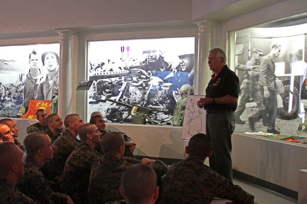 Arthur Barbosa, a retired Marine and docent, gives a class on Marine history to recruits of Company D, 1st Recruit Training Battalion, aboard Marine Corps Recruit Depot San Diego, Dec. 19. The class took place during a tour of the Command Museum aboard MCRD San Diego. 