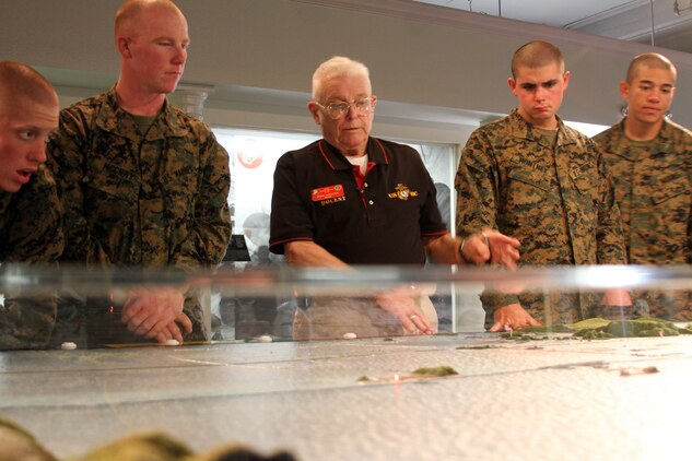 Mike Whaley, a retired Marine and docent, explains a scale model display of the Pacific Theatre of War to recruits of Company D, 1st Recruit Training Battalion,during their tour of the depot's Command Museum aboard Marine Corps Recruit Depot San Diego, Dec. 19. 