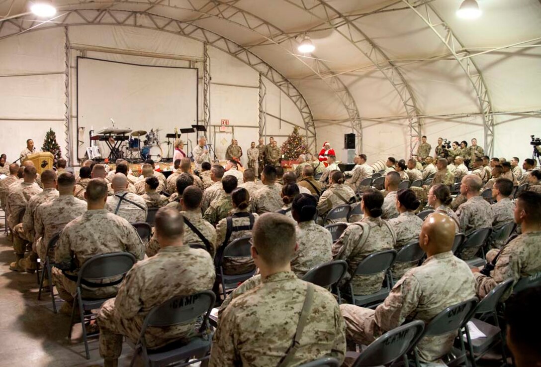 Commandant of the Marine Corps, Gen. James F. Amos and wife Bonnie Amos, address service members during a Christmas Eve extravaganza on Camp Leatherneck, Helmand province, Afghanistan, Dec. 24, 2012. Gen. Amos and wife Bonnie spent the holidays visiting service members currently deployed to Afghanistan in support of Operation Enduring Freedom. (U.S. Marine Corps photo by SSgt. Ezekiel R. Kitandwe/Released)