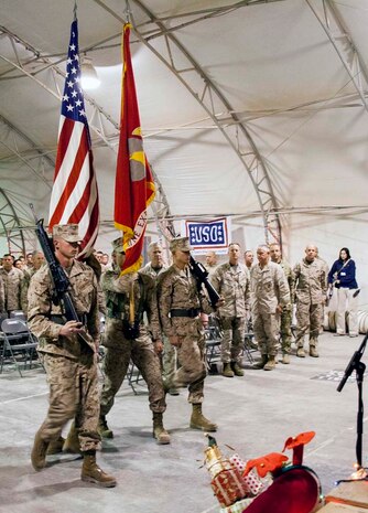 A U.S. Marine Corps color detail match on the colors during a Christmas Eve extravaganza where Commandant of the Marine Corps, Gen. James F. Amos and wife Bonnie Amos, were special guests on Camp Leatherneck, Helmand province, Afghanistan, Dec. 24, 2012. Gen. Amos and wife Bonnie spent the holidays visiting service members currently deployed to Afghanistan in support of Operation Enduring Freedom. (U.S. Marine Corps photo by SSgt. Ezekiel R. Kitandwe/Released)