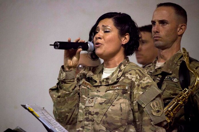 U.S. Air Force Tech. Sgt. Frances Kness, vocalist, U.S. Air Force Central Command band, performs at a Christmas Eve extravaganza where Commandant of the Marine Corps, Gen. James F. Amos and wife Bonnie Amos, were special guests on Camp Leatherneck, Helmand province, Afghanistan, Dec. 24, 2012. Gen. Amos and wife Bonnie spent the holidays visiting service members currently deployed to Afghanistan in support of Operation Enduring Freedom. (U.S. Marine Corps photo by SSgt. Ezekiel R. Kitandwe/Released)