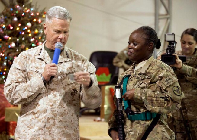 Commandant of the Marine Corps, Gen. James F. Amos, verifies the birthday of a winning contestant, during a Christmas Eve extravaganza on Camp Leatherneck, Helmand province, Afghanistan, Dec. 24, 2012. Gen. Amos and wife Bonnie Amos spent the holidays visiting service members currently deployed to Afghanistan in support of Operation Enduring Freedom. (U.S. Marine Corps photo by SSgt. Ezekiel R. Kitandwe/Released)