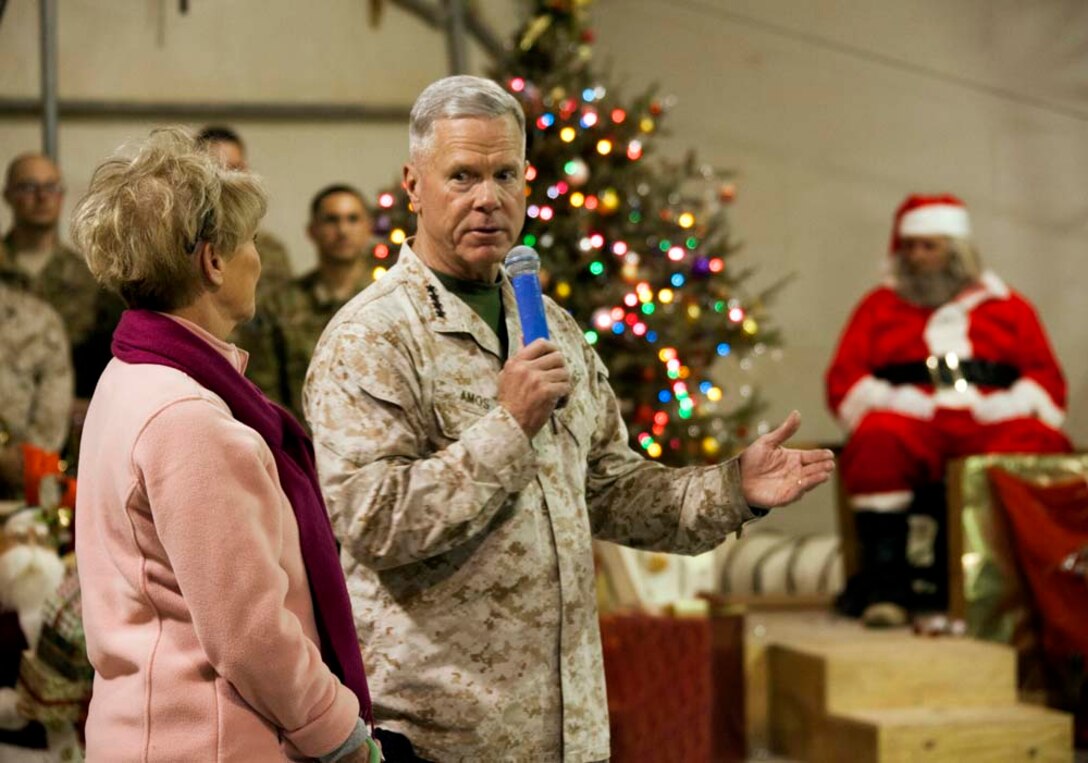 Commandant of the Marine Corps, Gen. James F. Amos and wife Bonnie Amos, address service members during a Christmas Eve extravaganza on Camp Leatherneck, Helmand province, Afghanistan, Dec. 24, 2012. Gen. Amos and wife Bonnie spent the holidays visiting service members currently deployed to Afghanistan in support of Operation Enduring Freedom. (U.S. Marine Corps photo by SSgt. Ezekiel R. Kitandwe/Released)