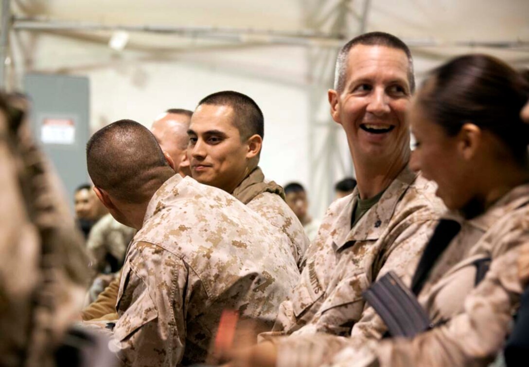 U.S. Marine service members share a moment during a Christmas Eve extravaganza where Commandant of the Marine Corps, Gen. James F. Amos and wife Bonnie Amos, were special guests  on Camp Leatherneck, Helmand province, Afghanistan, Dec. 24, 2012. Gen. Amos and wife Bonnie spent the holidays visiting service members currently deployed to Afghanistan in support of Operation Enduring Freedom. (U.S. Marine Corps photo by SSgt. Ezekiel R. Kitandwe/Released)