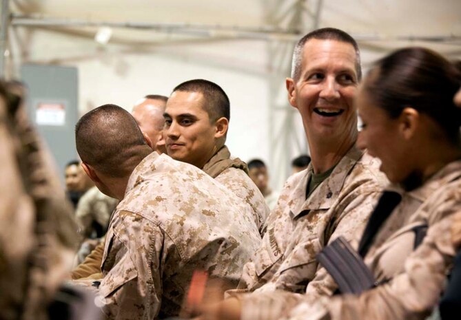 U.S. Marine service members share a moment during a Christmas Eve extravaganza where Commandant of the Marine Corps, Gen. James F. Amos and wife Bonnie Amos, were special guests  on Camp Leatherneck, Helmand province, Afghanistan, Dec. 24, 2012. Gen. Amos and wife Bonnie spent the holidays visiting service members currently deployed to Afghanistan in support of Operation Enduring Freedom. (U.S. Marine Corps photo by SSgt. Ezekiel R. Kitandwe/Released)