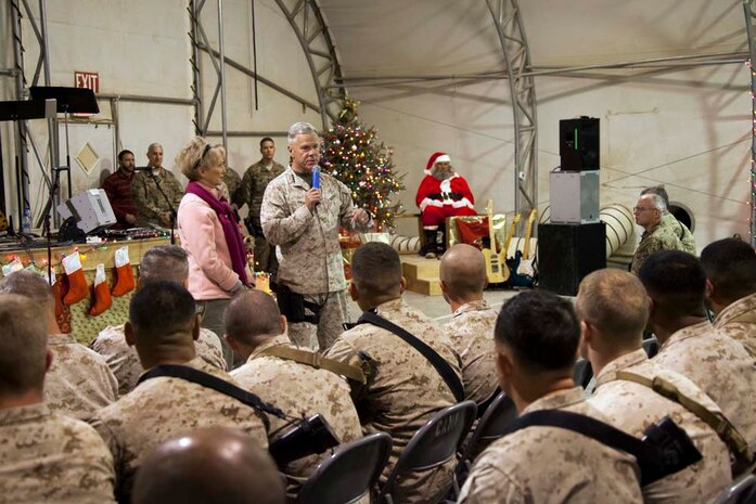 Commandant of the Marine Corps, Gen. James F. Amos and wife Bonnie Amos, address service members during a Christmas Eve extravaganza on Camp Leatherneck, Helmand province, Afghanistan, Dec. 24, 2012. Gen. Amos and wife Bonnie spent the holidays visiting service members currently deployed to Afghanistan in support of Operation Enduring Freedom. (U.S. Marine Corps photo by SSgt. Ezekiel R. Kitandwe/Released)
