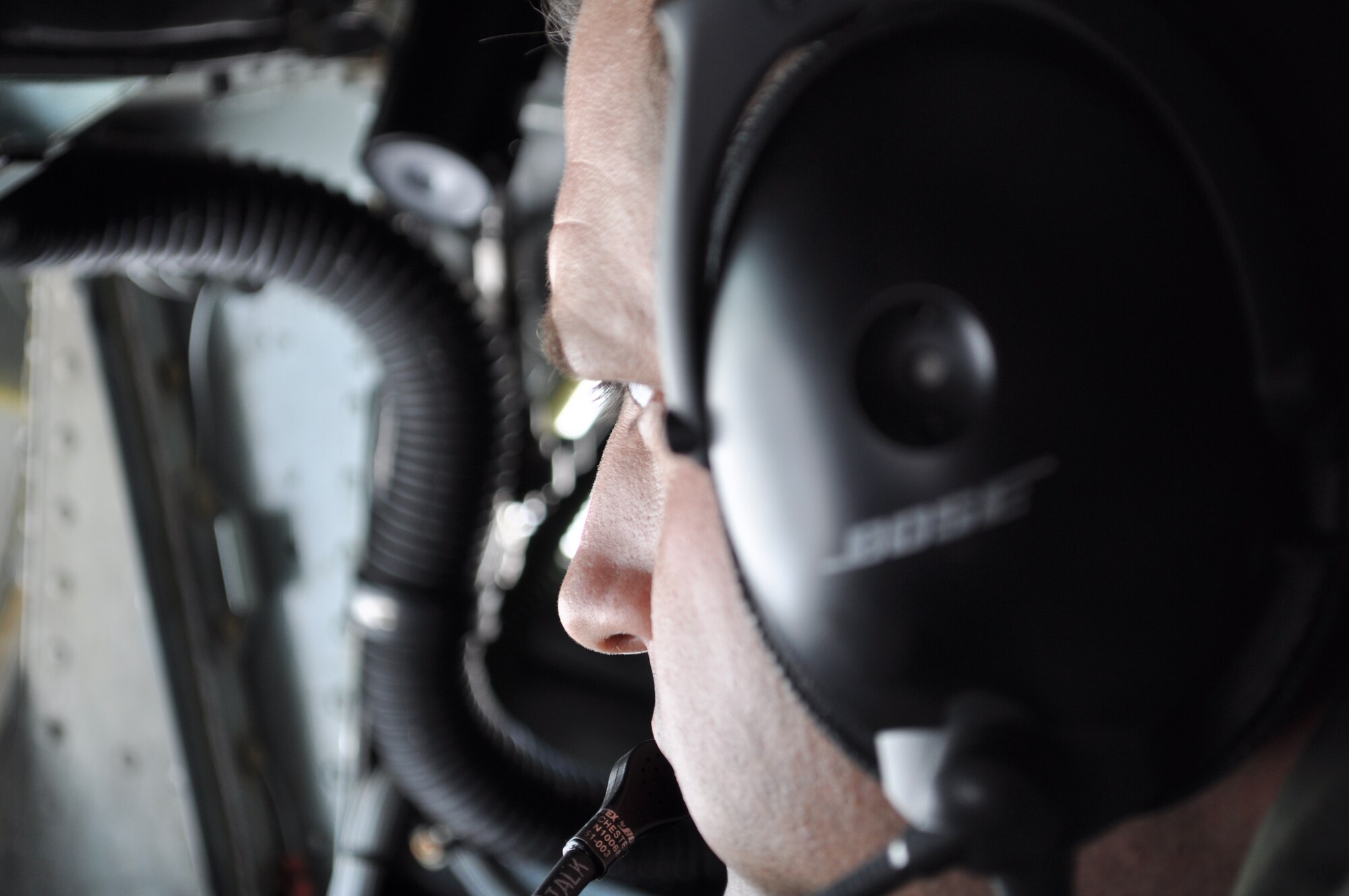 465th Air Refueling Squadron Boom Operator, Jeff Bass, intensely focuses on the E-3 AWACS  moving back and forth less than 50 feet from the tail of a KC-135.  Bass coordinates the aerial refueling for more than one-hour and forty minutes as pilots of both planes rely on his skill to the planes safe while off-loading 50,000 gallons of fuel.  