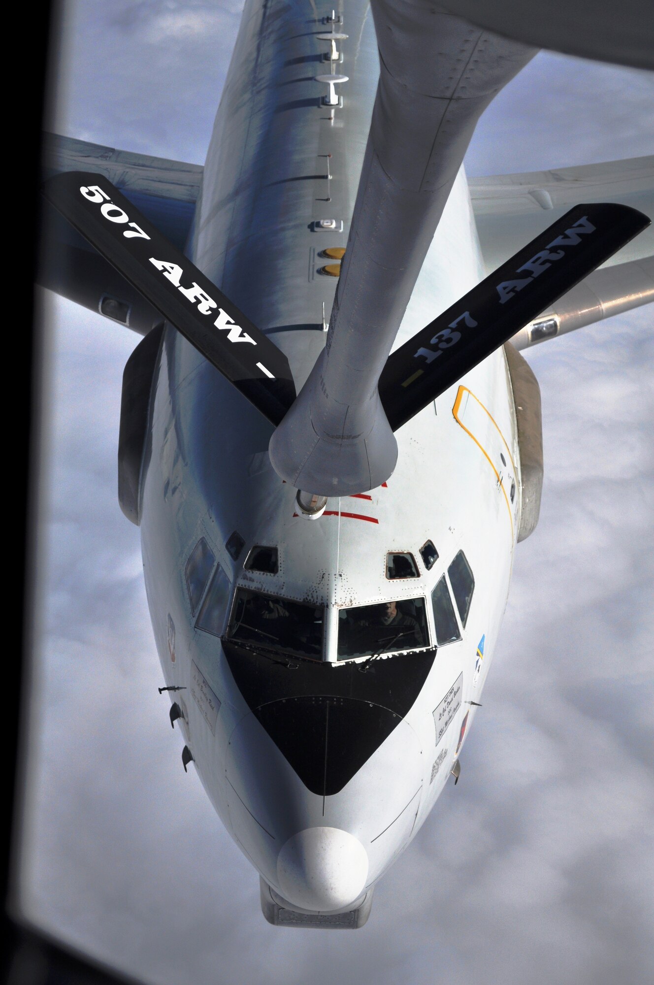 An E-3 Sentry moves to within 50 feet of a KC-135 from the 507 ARW recently as the two planes prepare for an aerial refueling over the cloudy skies of St. Louis.  