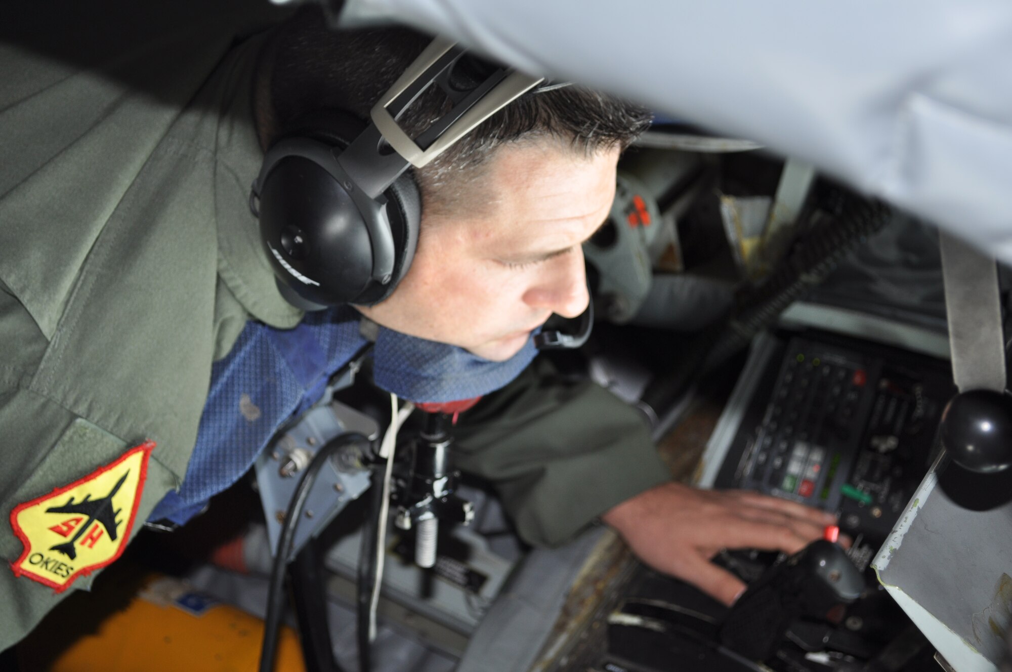 Master Sgt. Jeff Bass, 465th Air Refueling Squadron Boom Operator rests his chin in preparation for a training mission with the 966th Airborne Air Control Squadron out of Tinker Air Force Base.  Bass sends a series of light signals to the pilots of the E-3 Sentry to guide them in for connection with the boom.  