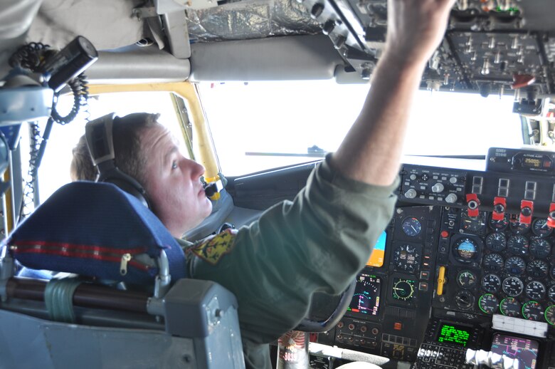 Maj. Jeff Milburn of the 465th Air Refueling Squadron checks some gauges as he prepares the KC-135 for a rendezvous with an E-3 Sentry for an aerial refueling recently.  