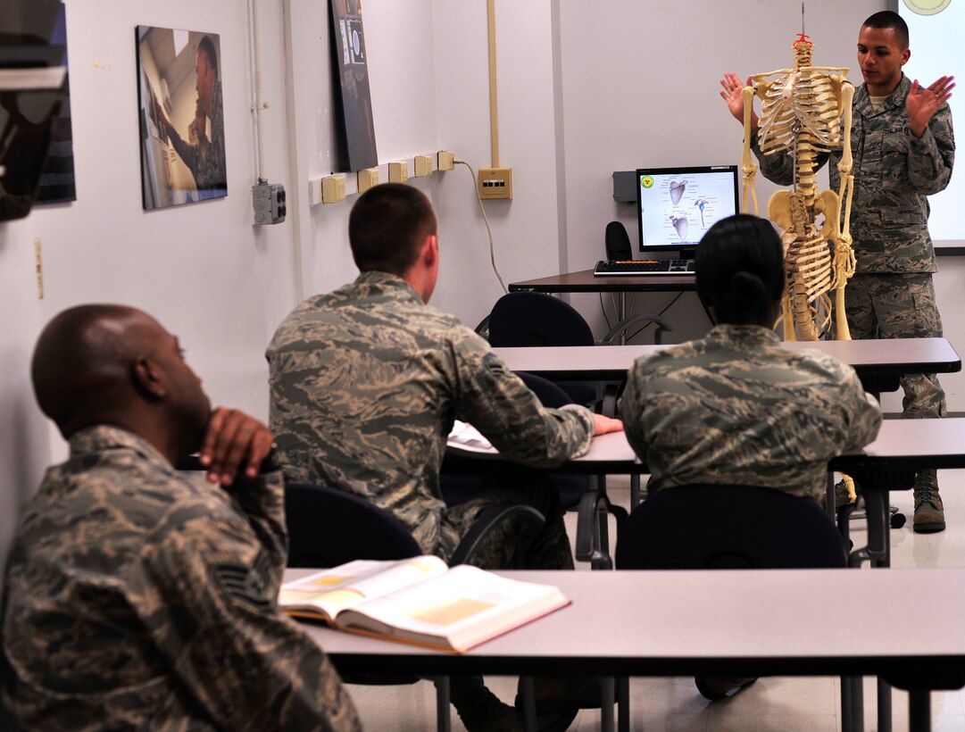 Airman 1st Class Rebecca Riccardi and Airman Sarah Fairbanks, 779th Medical Group Diagnostic Imaging Phase II Students, practice positioning film for a chest X-Ray at the Malcolm Grow Medical Clinic, Dec. 19, 2012. The students are completing their last of two phases to complete their training. (U.S. Air Force photo/ Airman 1st Class Erin O’Shea)