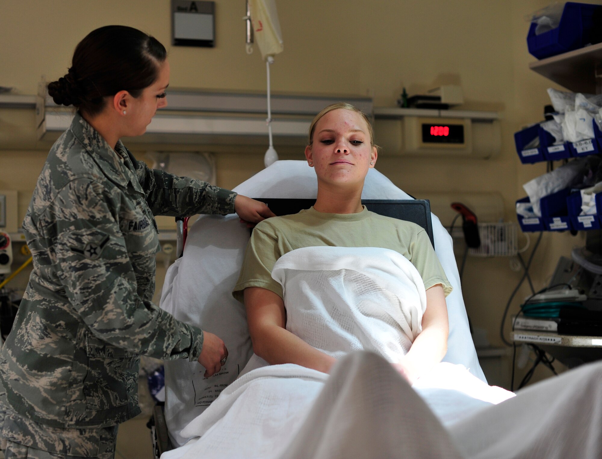 Airman 1st Class Rebecca Riccardi and Airman Sarah Fairbanks, 779th Medical Group Diagnostic Imaging Phase II Students, practice positioning film for a chest X-Ray at the Malcolm Grow Medical Clinic, Dec. 19, 2012. The students are completing their last of two phases to complete their training. (U.S. Air Force photo/ Airman 1st Class Erin O’Shea)
