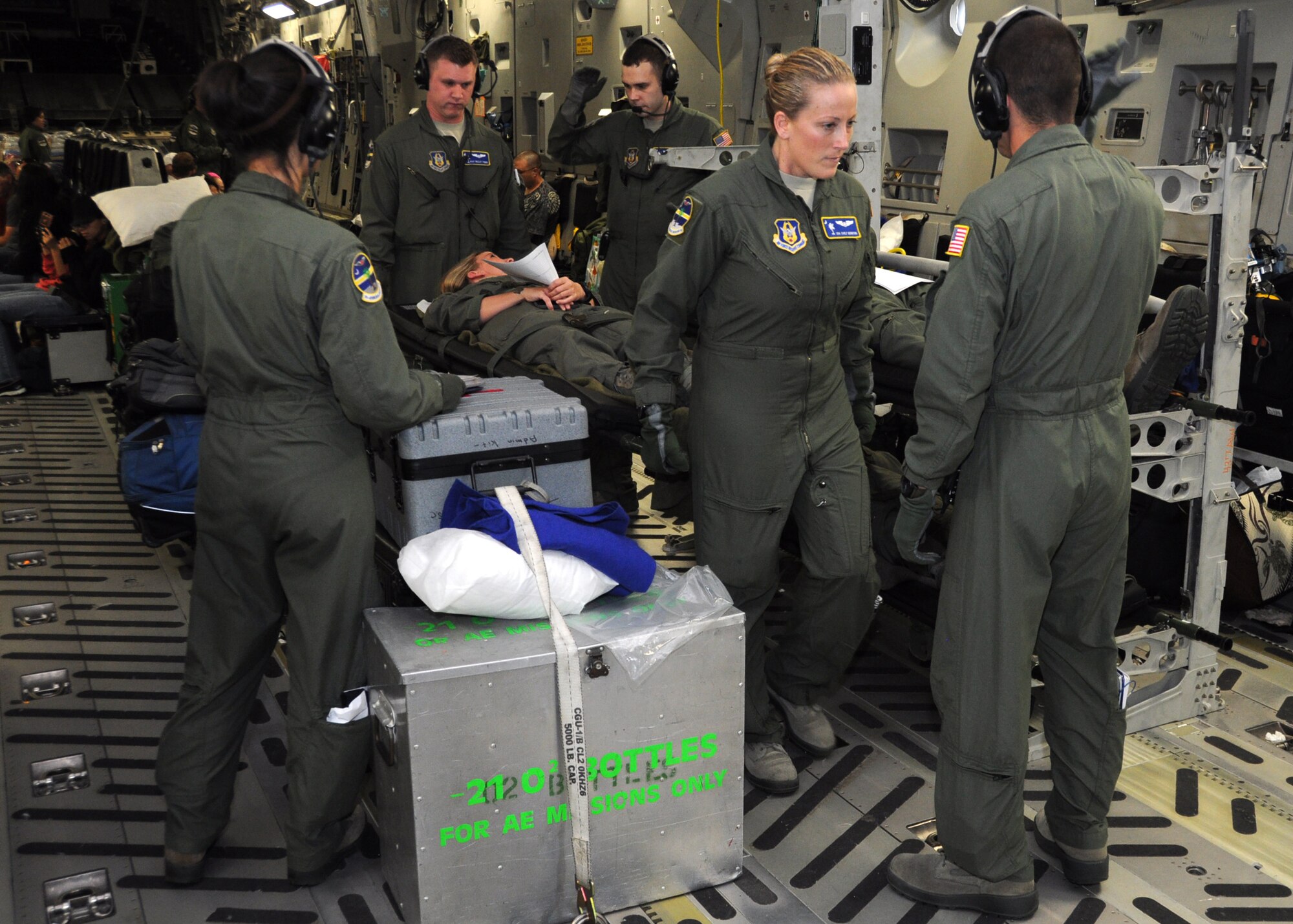 Airmen from the 315th Aeromedical Evacuation Squadron transport a patient on a litter as they prepare for a training mission Jan. 1, 2012 at Joint Base Pearl Harbor-Hickam, Hawaii. The AES mission allowed the medical team to practice their skills on various elements of patient care and they were given multiple training scenarios to combat in flight emergencies. (U.S. Air Force Photo/Staff Sgt. Shane Ellis)