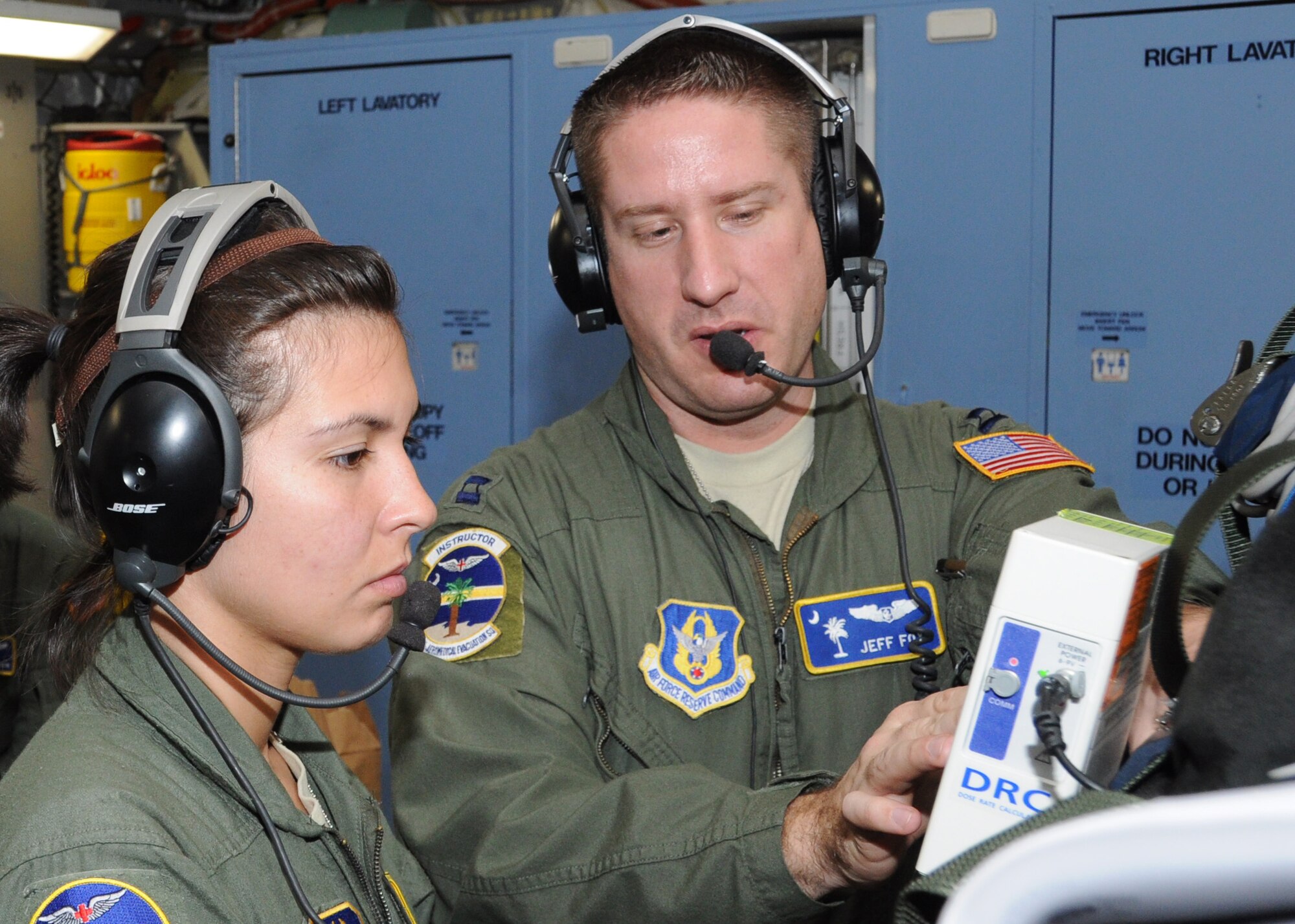 Capt. Jef Fox, 315th Aeromedical Evacuation Squadron flight nurse, demonstrates proper operation of medical equipment to Senior Airman Jasmine Arias, 315 AES medical technician, during a training flight Jan. 1, 2012 over Joint Base Pearl Harbor-Hickam, Hawaii. The AES mission allowed the medical team to practice their skills on various elements of patient care and they were given multiple training scenarios to combat in flight emergencies. (U.S. Air Force Photo/Staff Sgt. Shane Ellis)