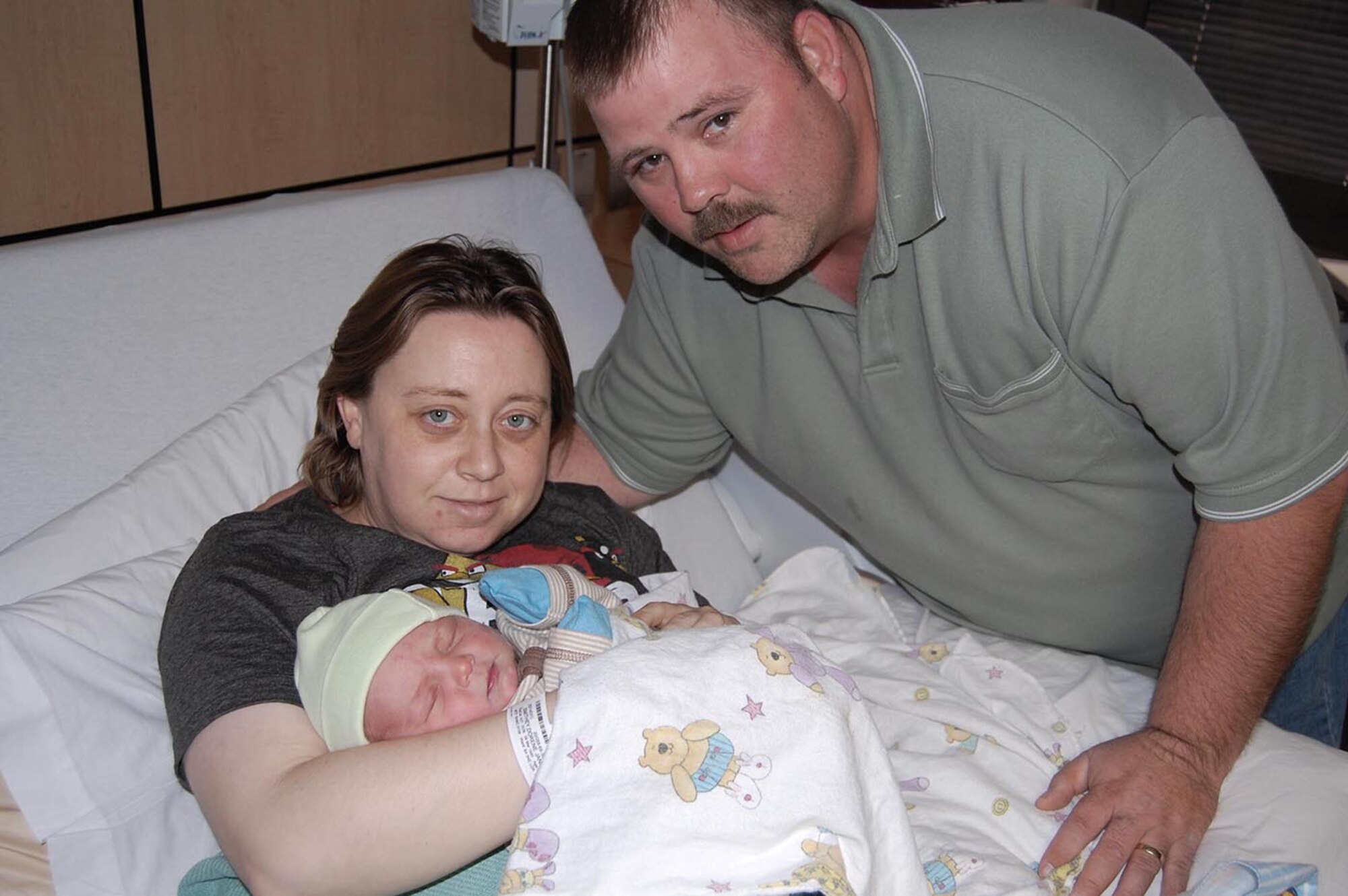 Juston and Dorene Smithey pose for a family photo with their first born, AJ Smithey, in San Antonio Military Medical Center’s Labor, Delivery and Recovery ward. AJ, who was SAMMC’s first delivery of 2013, was born at 3:50 a.m. on New Year’s Day. (U.S. Army photo/Robert Shields)