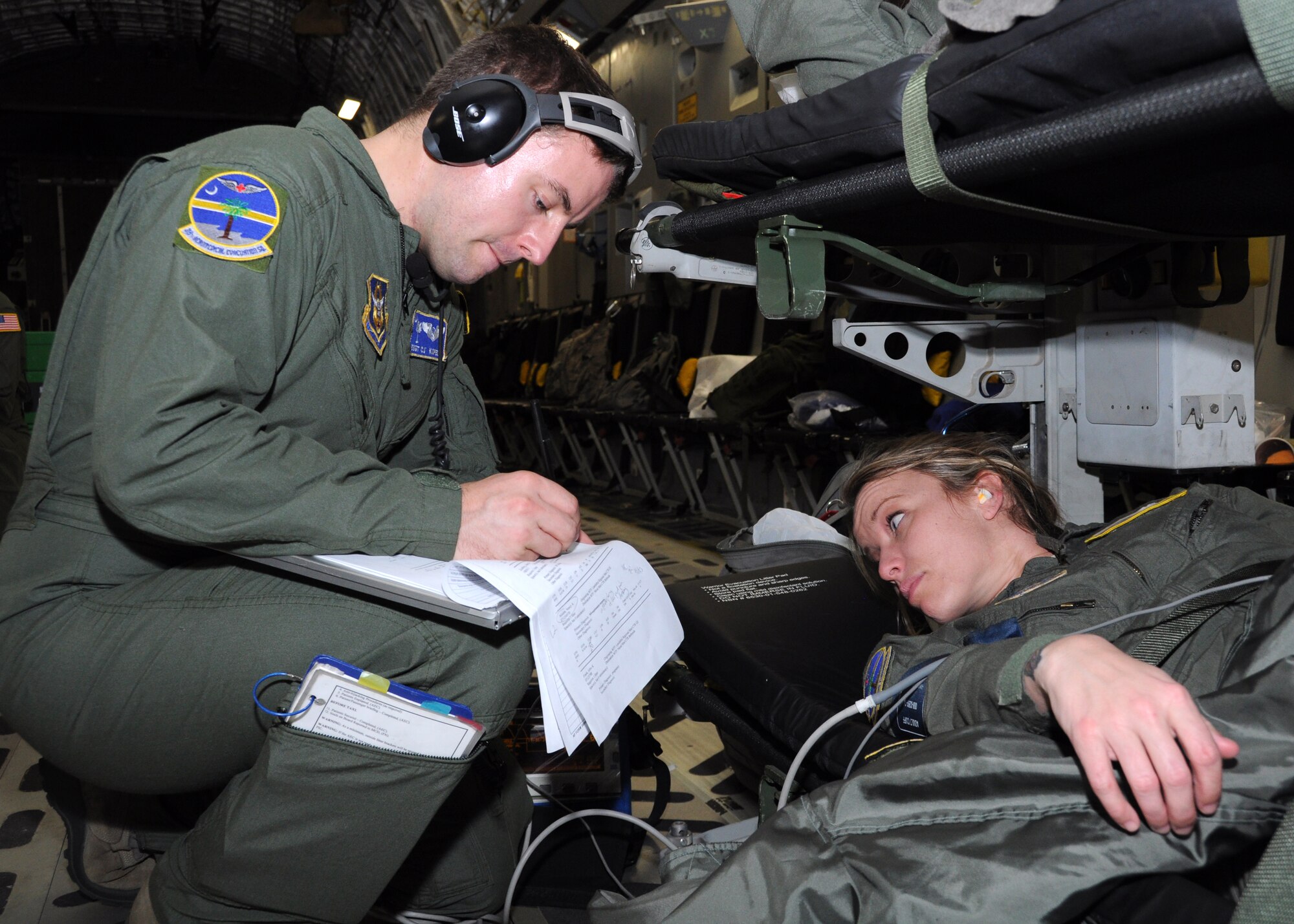 Staff Sgt. C.J. Kopeck, 315 Aeromedical Evacuation Squadron medical technician, monitors a patient’s vital signs during a training flight Jan. 1, 2012 over Joint Base Pearl Harbor-Hickam, Hawaii. The AES mission allowed the medical team to practice their skills on various elements of patient care and they were given multiple training scenarios to combat in flight emergencies. (U.S. Air Force Photo/Staff Sgt. Shane Ellis)