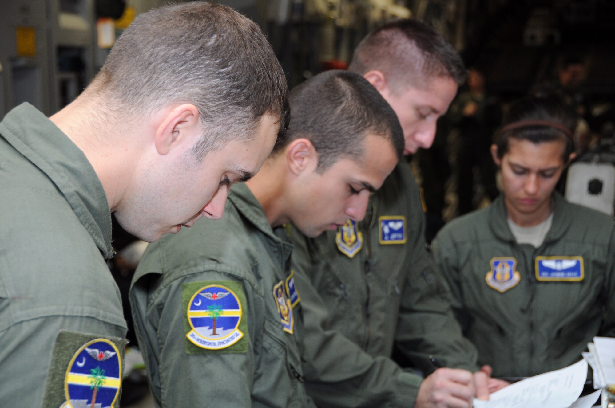 Airmen from the 315th Aeromedical Evacuation Squadron prepare for a training mission Jan. 1, 2012 at Joint Base Pearl Harbor-Hickam, Hawaii. The AES mission allowed the medical team to practice their skills on various elements of patient care and they were given multiple training scenarios to combat in flight emergencies. (U.S. Air Force Photo/Staff Sgt. Shane Ellis)
