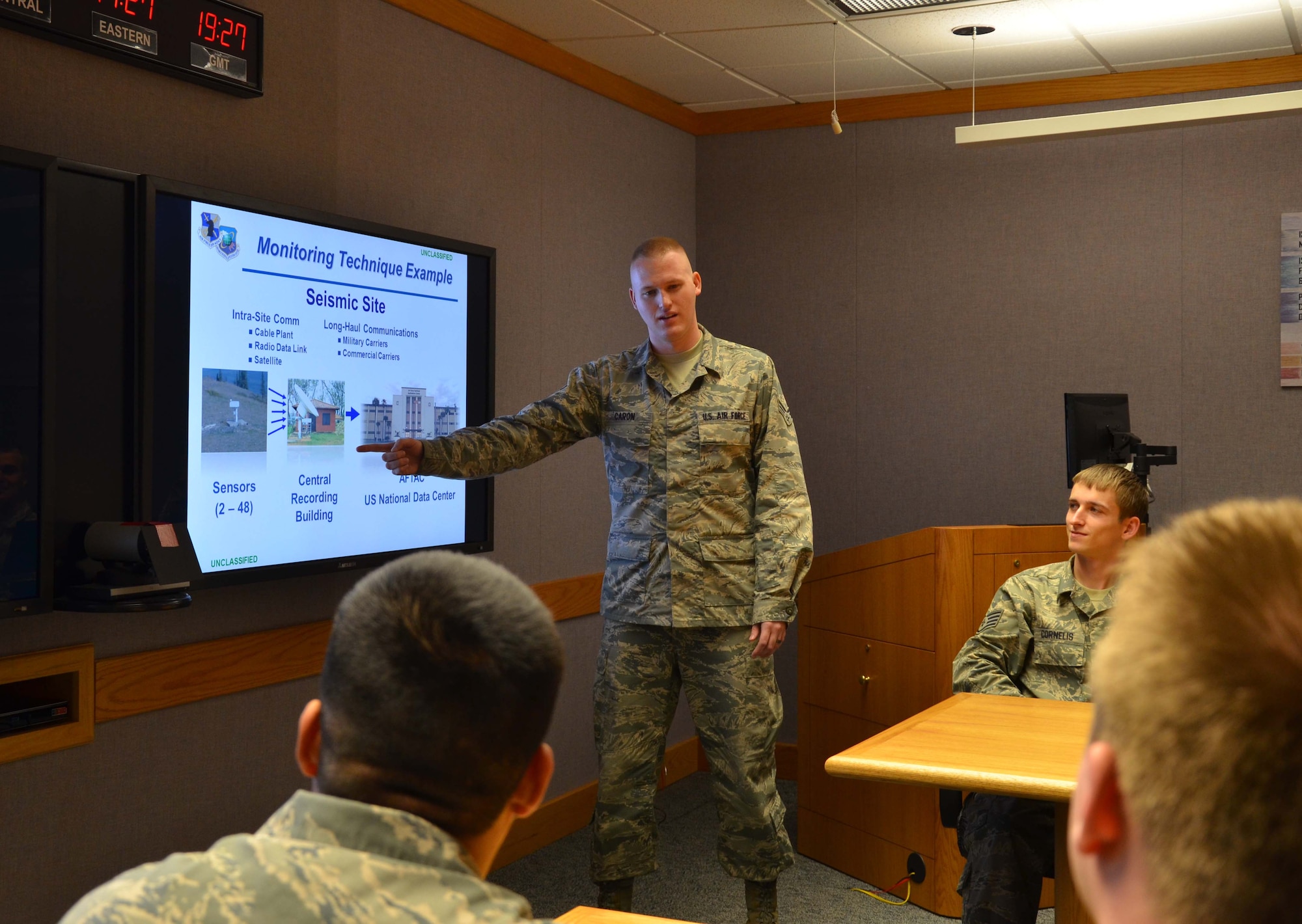 Senior Airman Jacob Caron, a systems control shift leader for the Air Force Technical Applications Center at Patrick AFB, Fla., briefs a group of technicians about seismic monitoring techniques the center uses to monitor nuclear treaties.  Caron was selected as the U.S. Air Force's Outstanding Scientific Applications Specialist-Technician of the Year for 2012.  The program’s objective is to award an individual for outstanding contributions to the technical applications specialist career field.   (U.S. Air Force photo by Susan A. Romano)