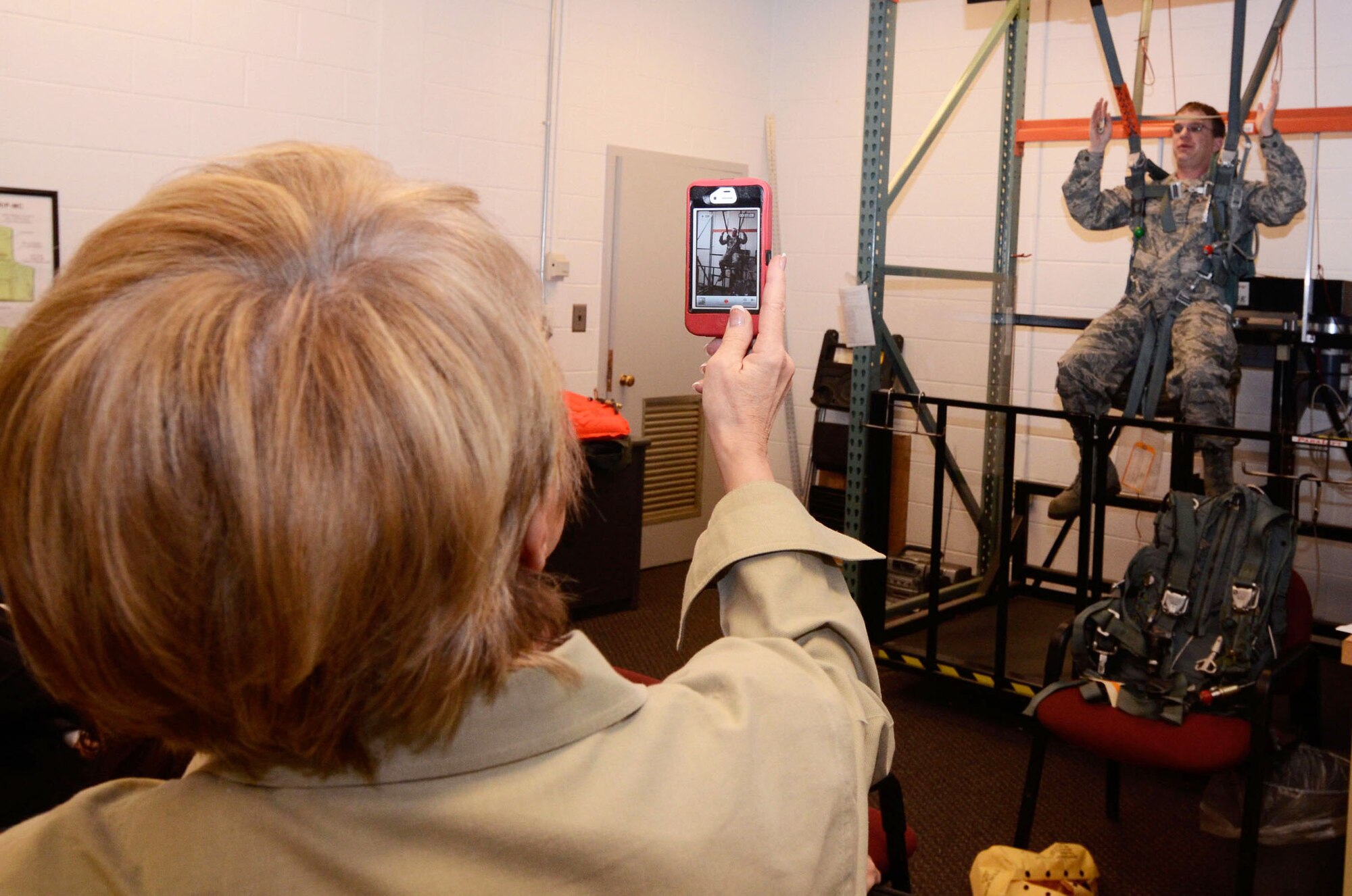 Staff Sgt. Scott McDermott, Aircrew Flight Equipment craftsman, demonstrates a personal lowering device during a Hercules Community Council visit, Jan. 26. PLDs are used by aircrew to get to ground safely, if a parachute is caught in an object during a jump. (U.S. Air Force photo/Don Peek)