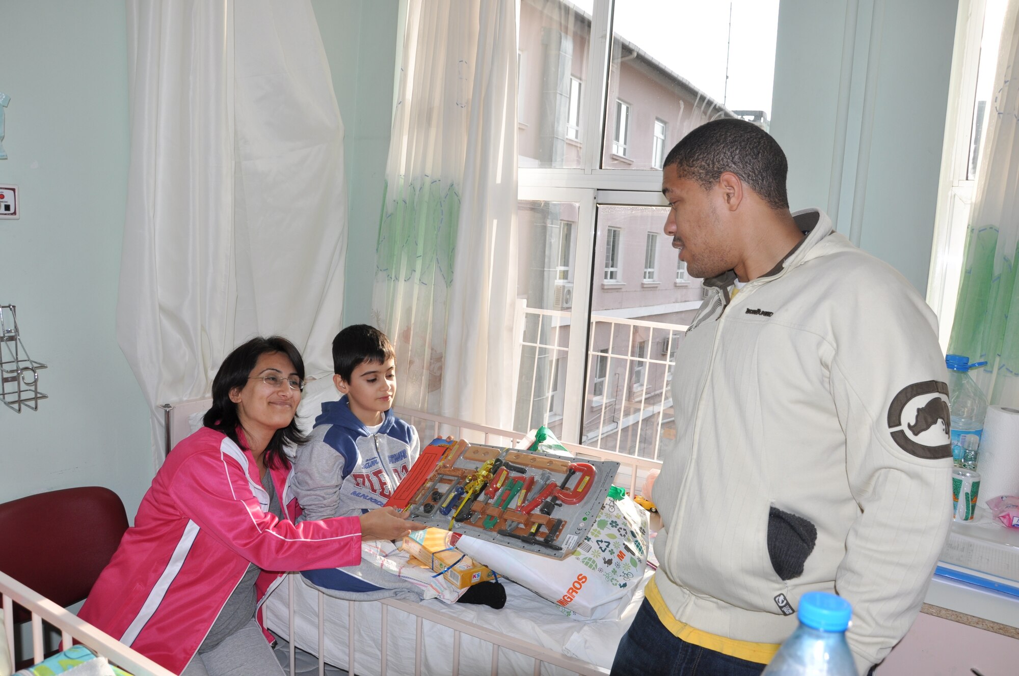 Staff Sgt. Rashad Noori, 425th Air Base Squadron financial services NCOIC in Izmir, Turkey, gives a toy to a Turkish child at an Izmir children’s hospital Dec. 21, 2012. Noori, a member of the air station’s enlisted council, visited the hospital as part of a toy drive by the chaplain’s office to provide the children toys and gifts. More than 163 children received gifts. (U.S. Air Force photo by Tanju Varlikli/Released)
