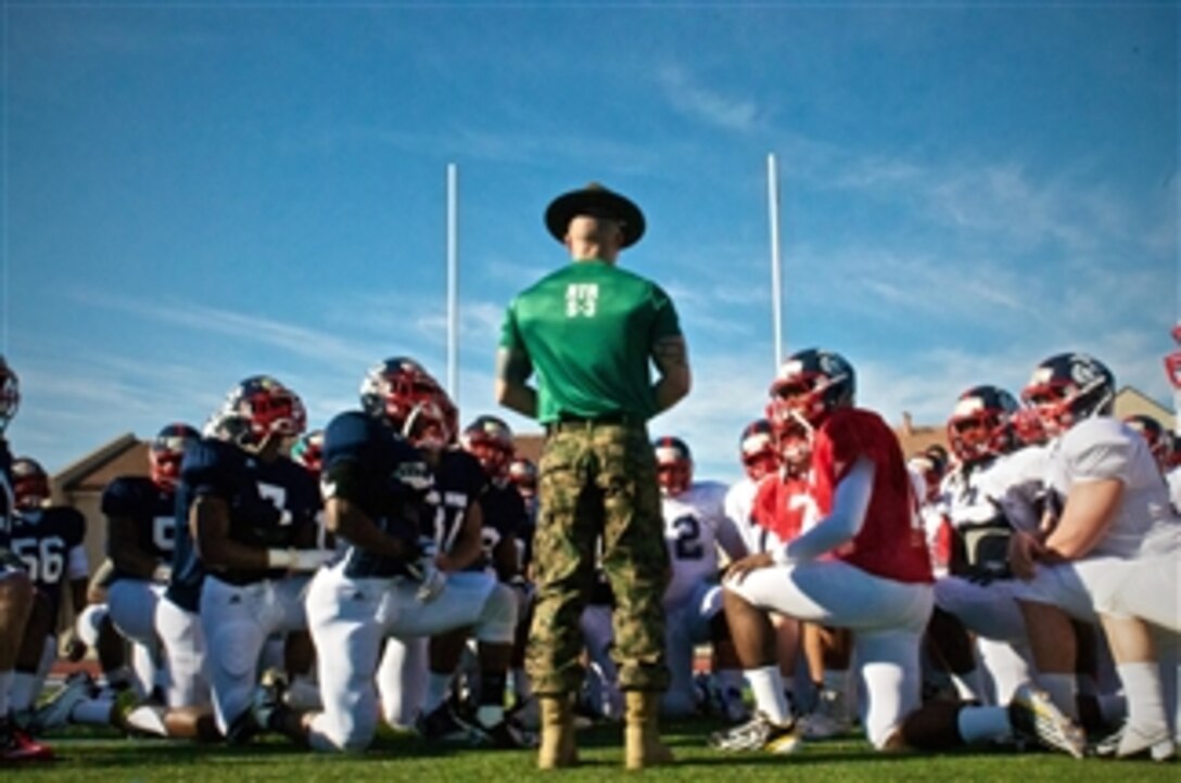 A Marine drill instructor from Marine Corps Recruit Depot San Diego gives a pep talk to the football players of the Semper Fidelis All-American bowl East Coast team during the players’ first practice at Fullerton College in Fullerton, Calif., on Dec. 31, 2012.  The Semper Fidelis All-American bowl game will be nationally televised live on the NFL network on Jan. 4th.  