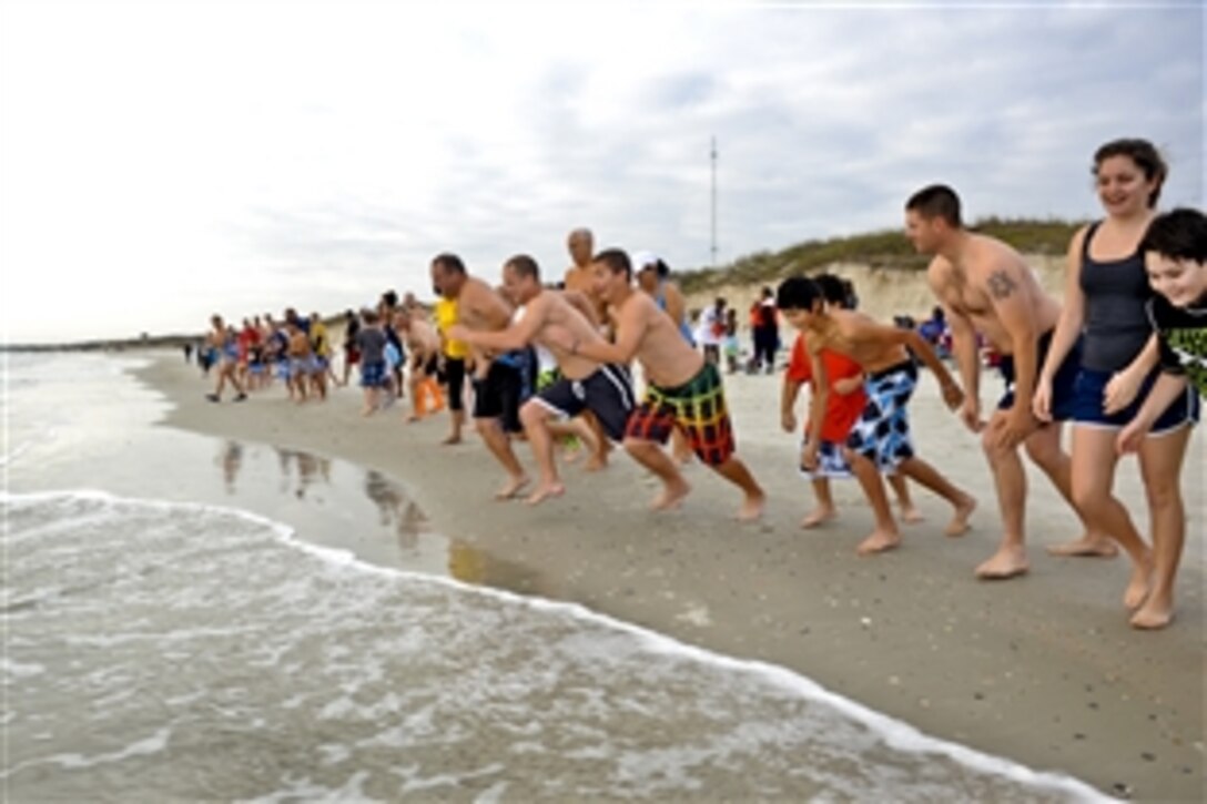 Service members, family and friends celebrate the new year by charging into the Atlantic Ocean during the Polar Plunge on Naval Station Mayport in Mayport, Fla., Jan. 1, 2013.